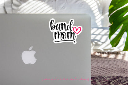 Pink Heart Band Mom sticker on the lid of a silver laptop