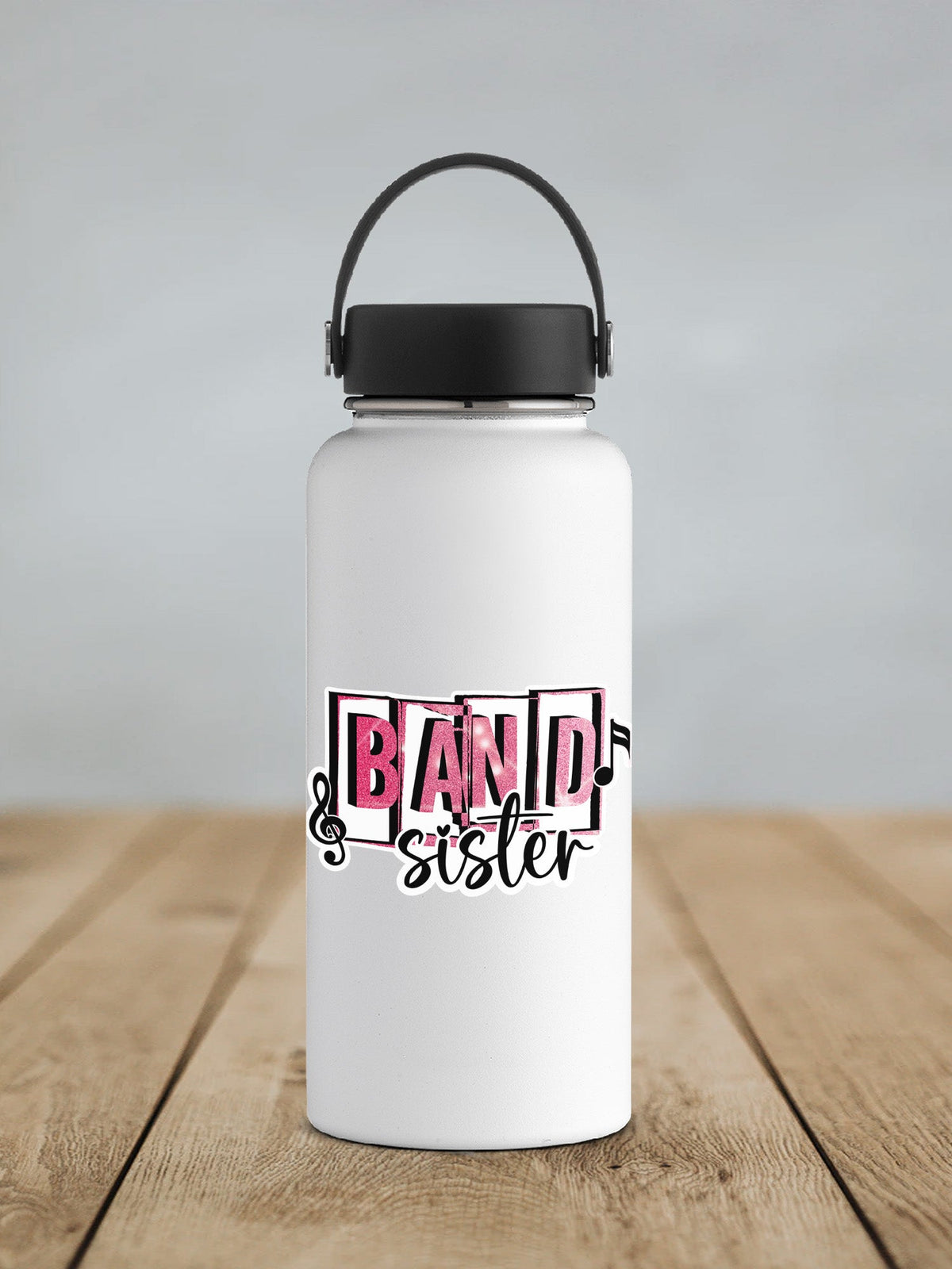 Pink Band Sister sticker on a white insulated water bottle