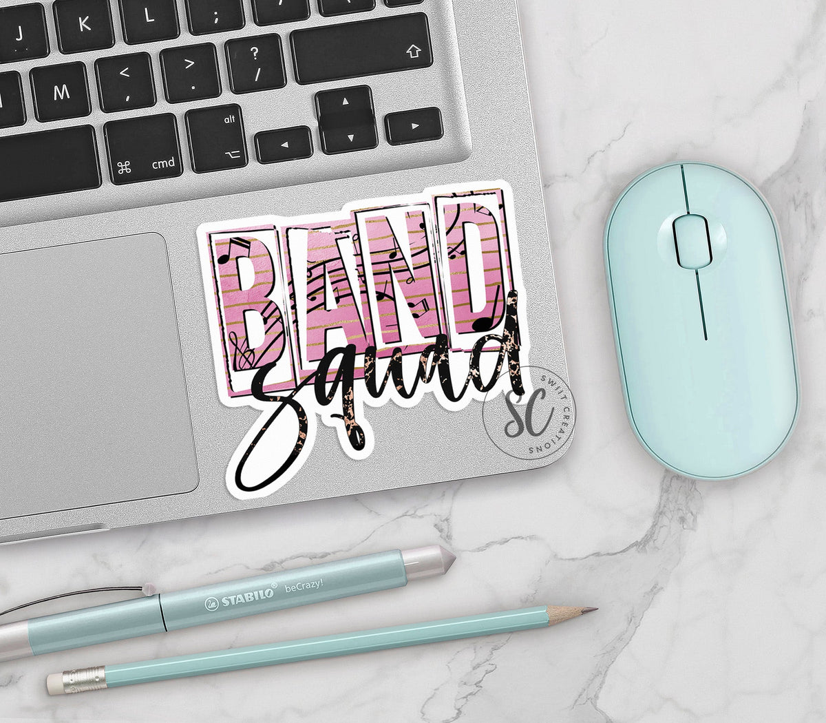 Band Squad vinyl sticker on a silver laptop next to a mint mouse and pens