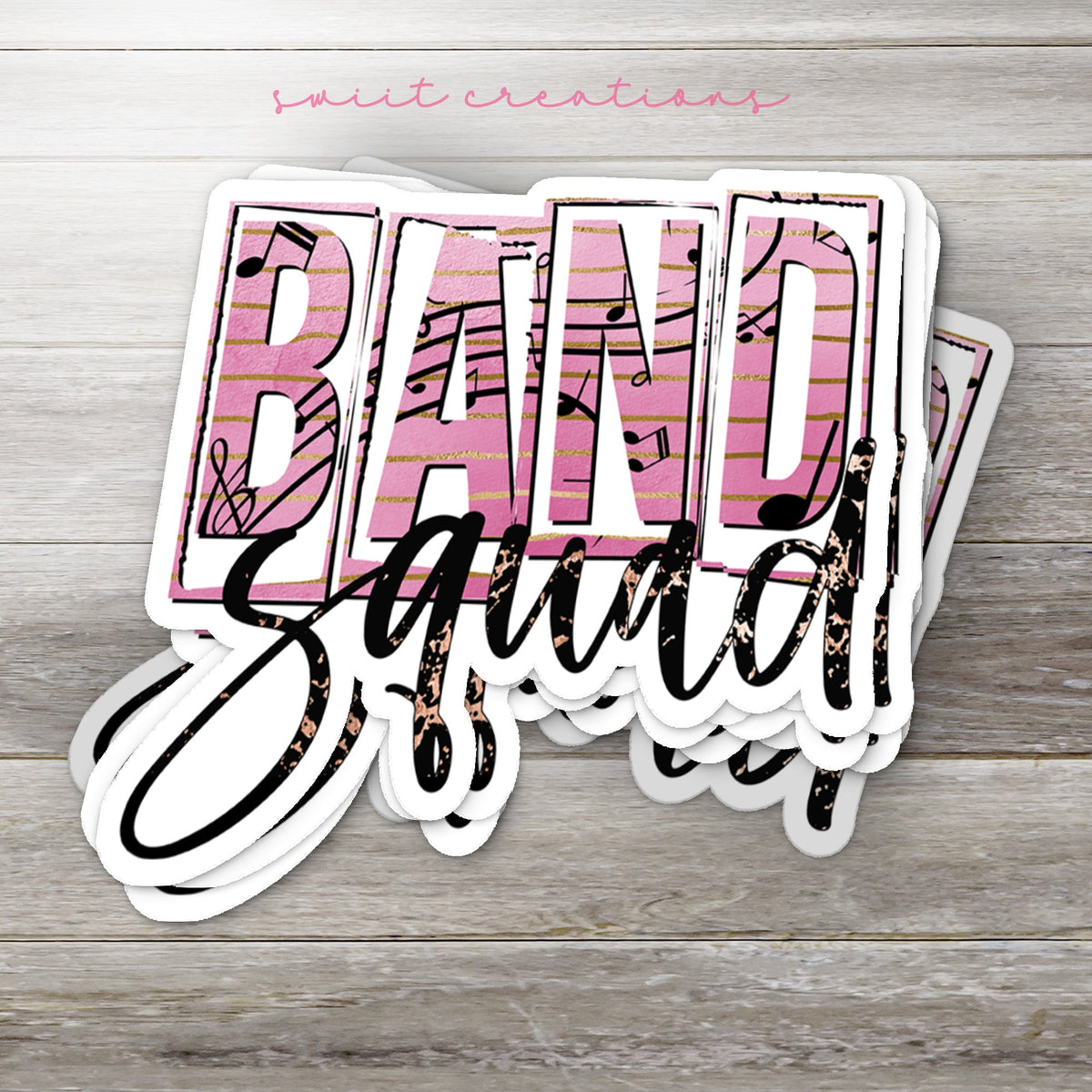 Stack of Band Squad glossy stickers on a gray wood table