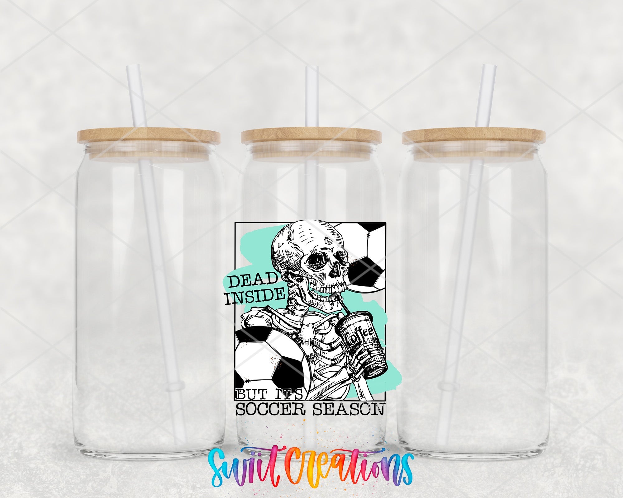 two clear tumblers with wooden lids with a skeleton holding a soccer ball
