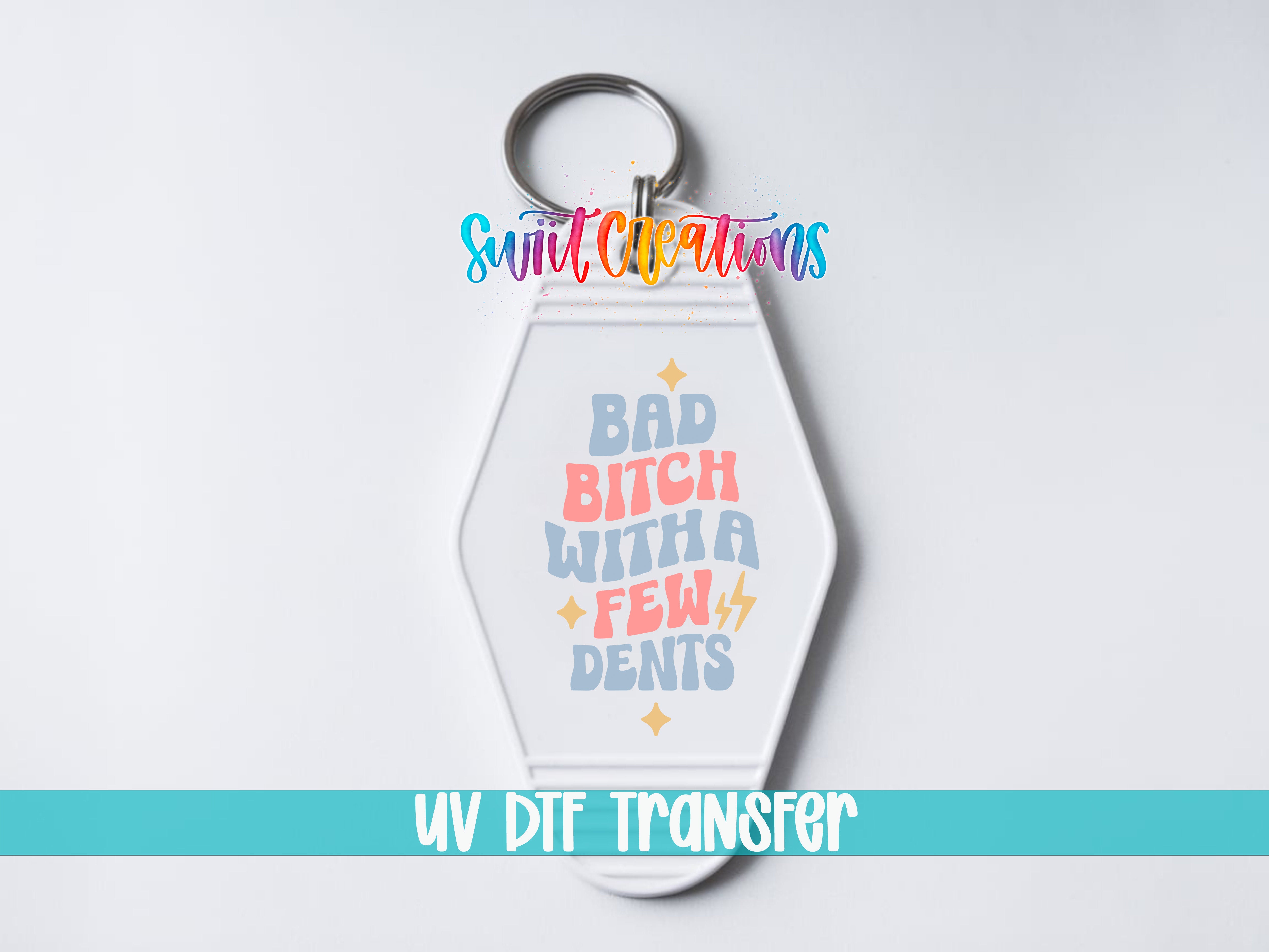 A keychain with a colorful design and text that says "Bad Bitch with a Few Dents".