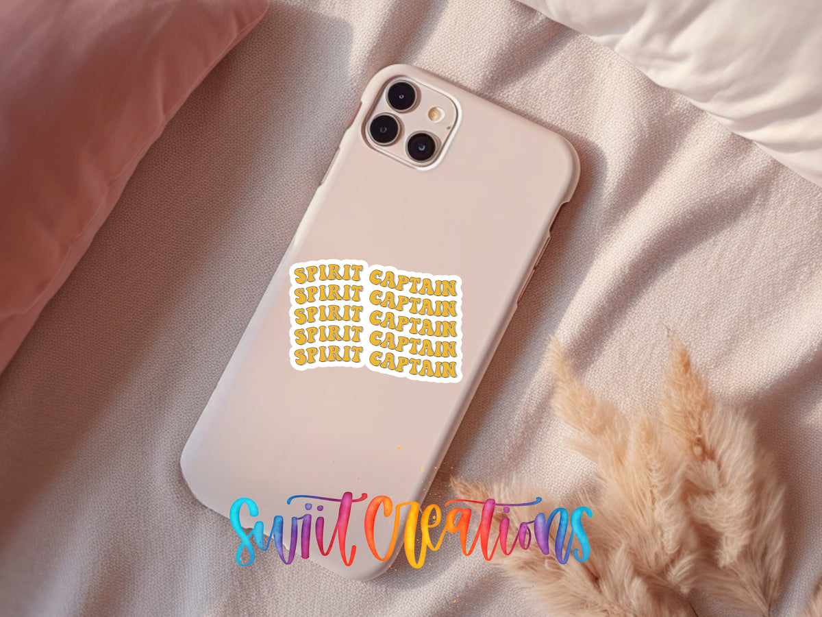 A white iPhone case with a sticker on it, placed on a pink pillow and a beige blanket.