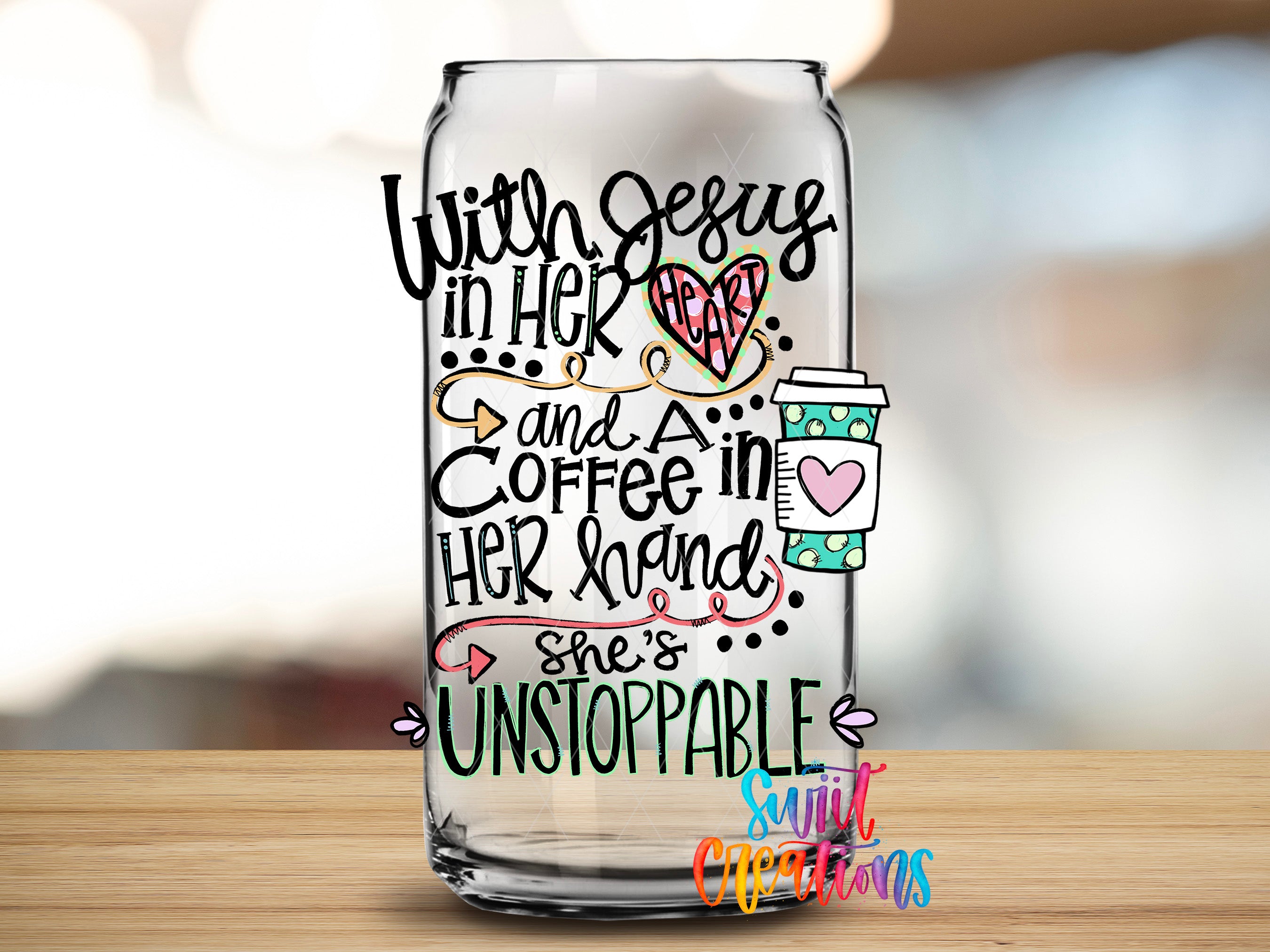 A glass can with hand-drawn text and illustrations on it, placed on a wooden surface.