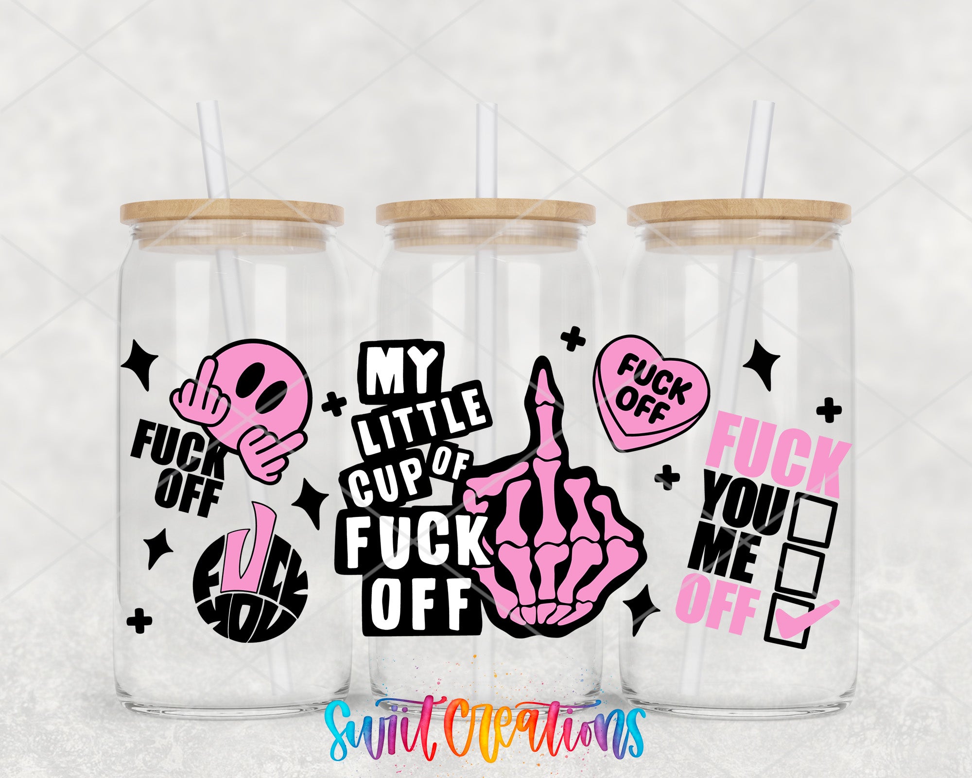 three clear glass tumblers with various text and graphics printed on them.