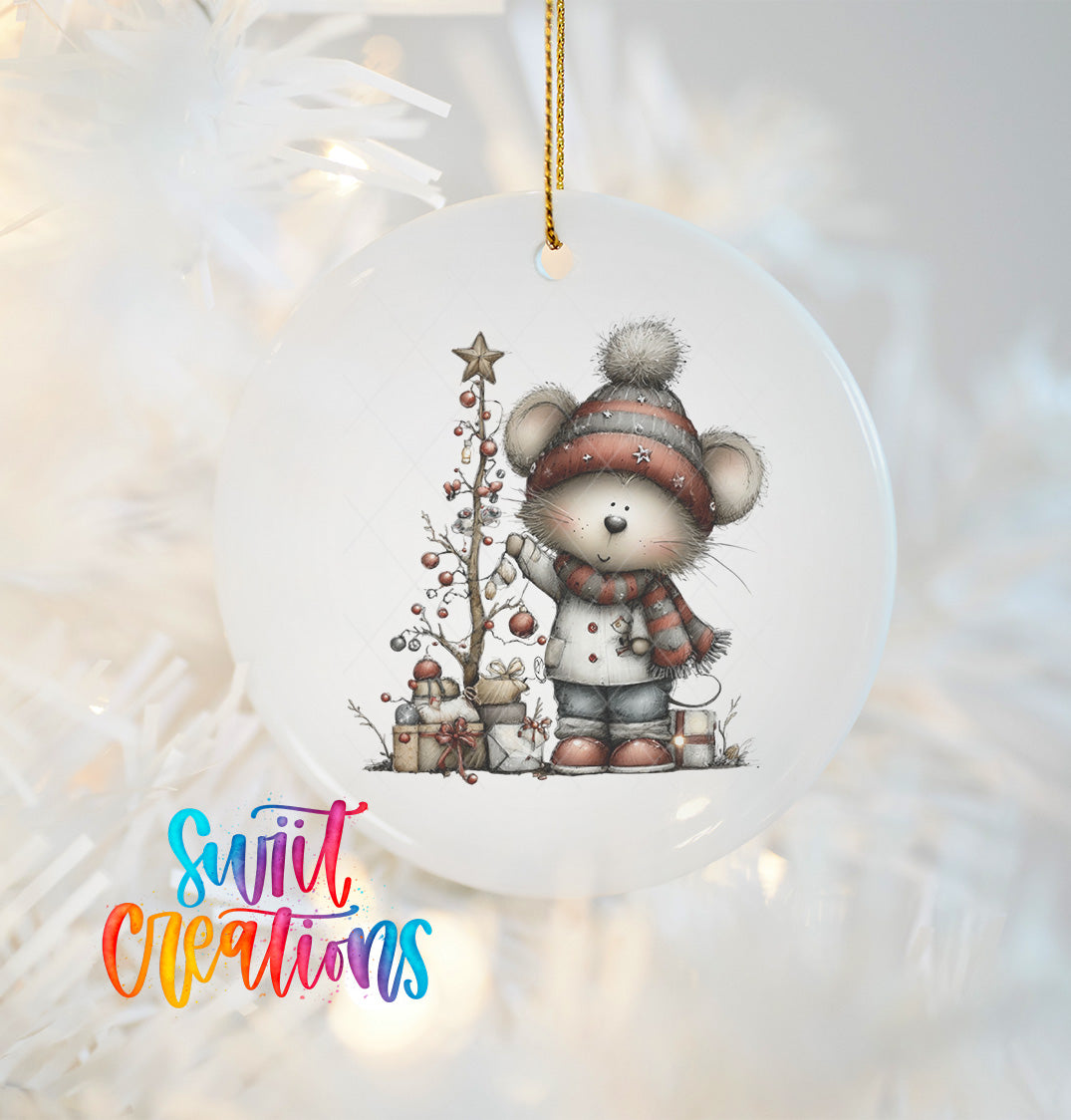 A white Christmas ornament featuring a cartoon mouse standing next to a Christmas tree, with presents and a star on the tree.