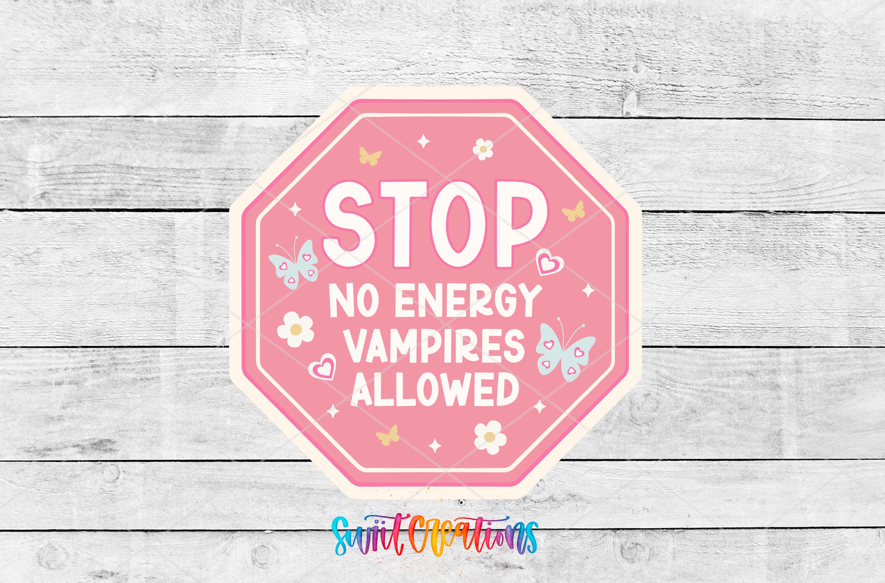 a pink stop sign with butterflies on it