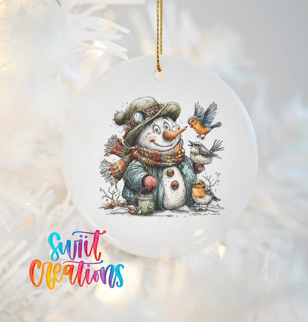 A snowman ornament with a bird perched on its head, surrounded by a scarf and other winter accessories, is hanging on a Christmas tree.