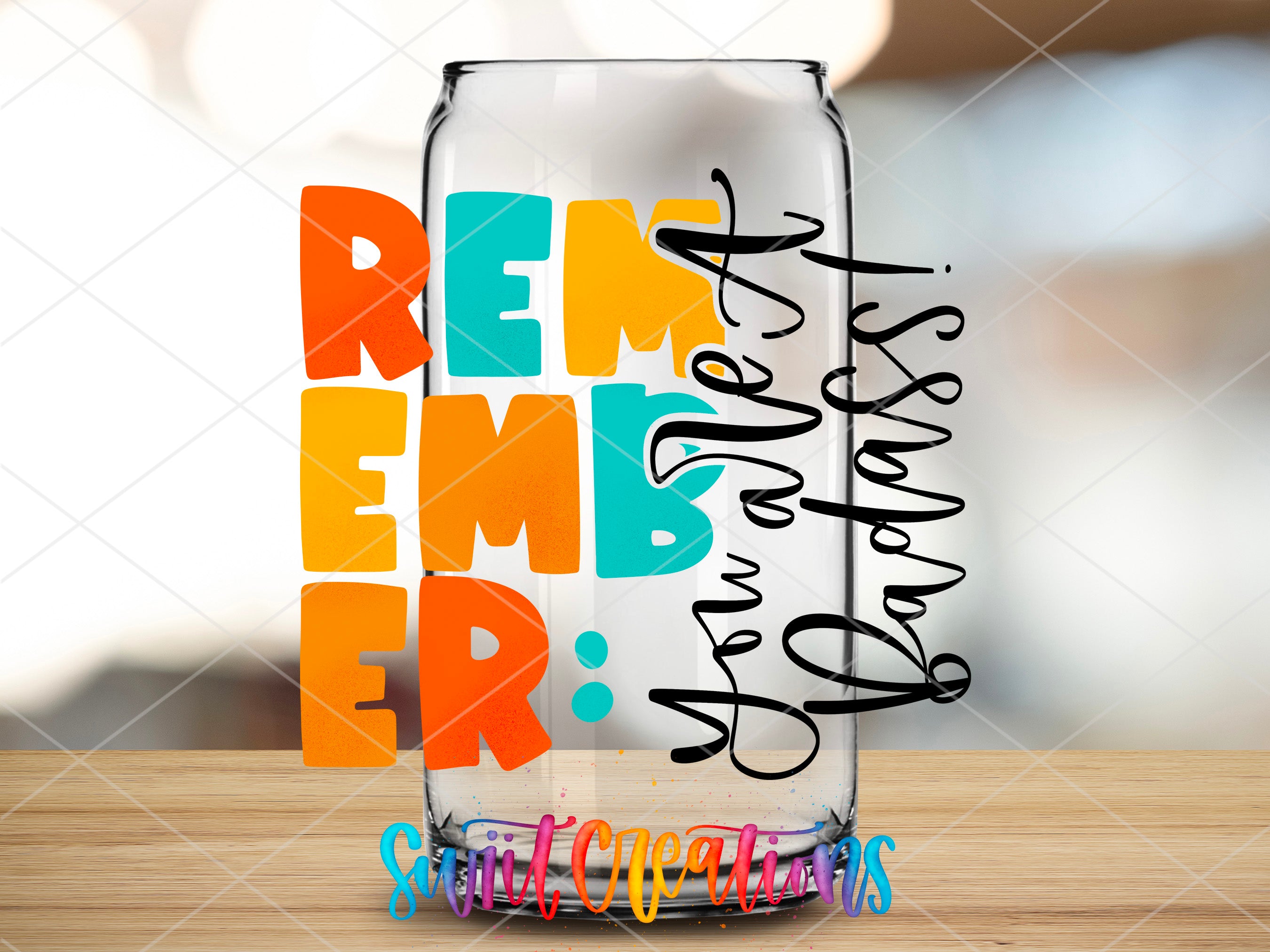 a glass with some writing on it sitting on a table