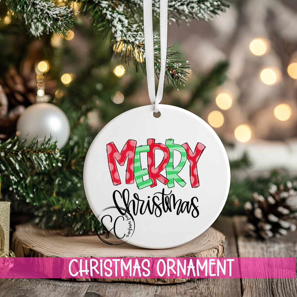 a merry christmas ornament hanging from a christmas tree