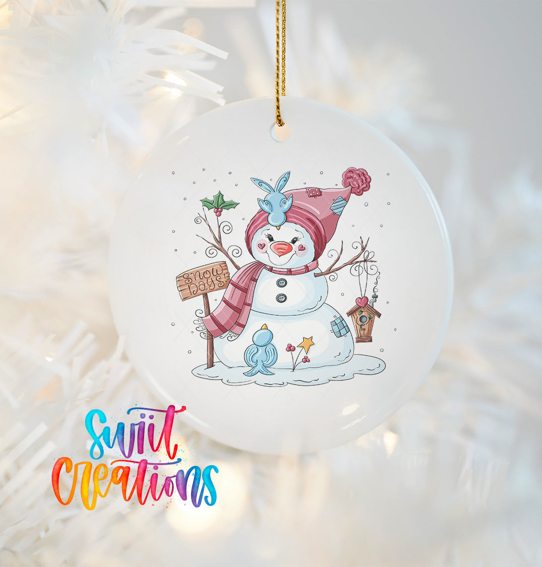 A white ornament featuring a snowman with a sign, surrounded by various winter-themed elements such as a bird, flowers, and a snowflake.