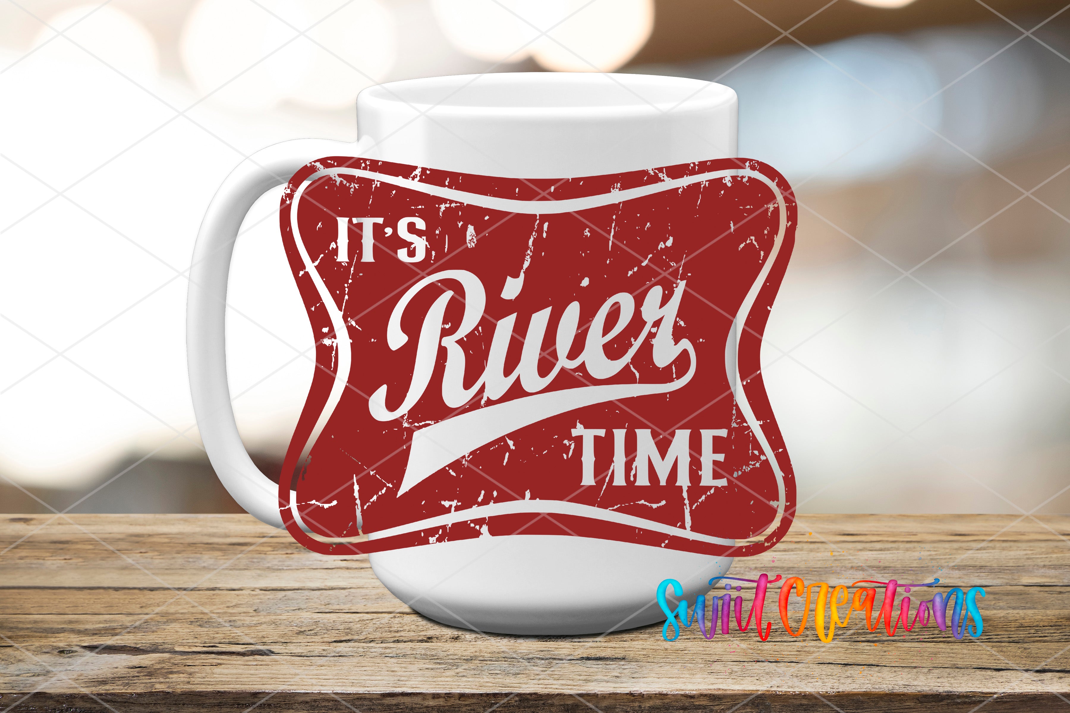 A white mug with a red and white sticker that says "It's River Time" on it, placed on a wooden surface.