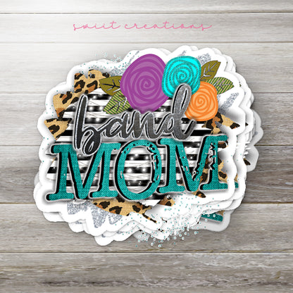 Stack of Leopard Floral Band Mom glossy stickers on a gray wood table