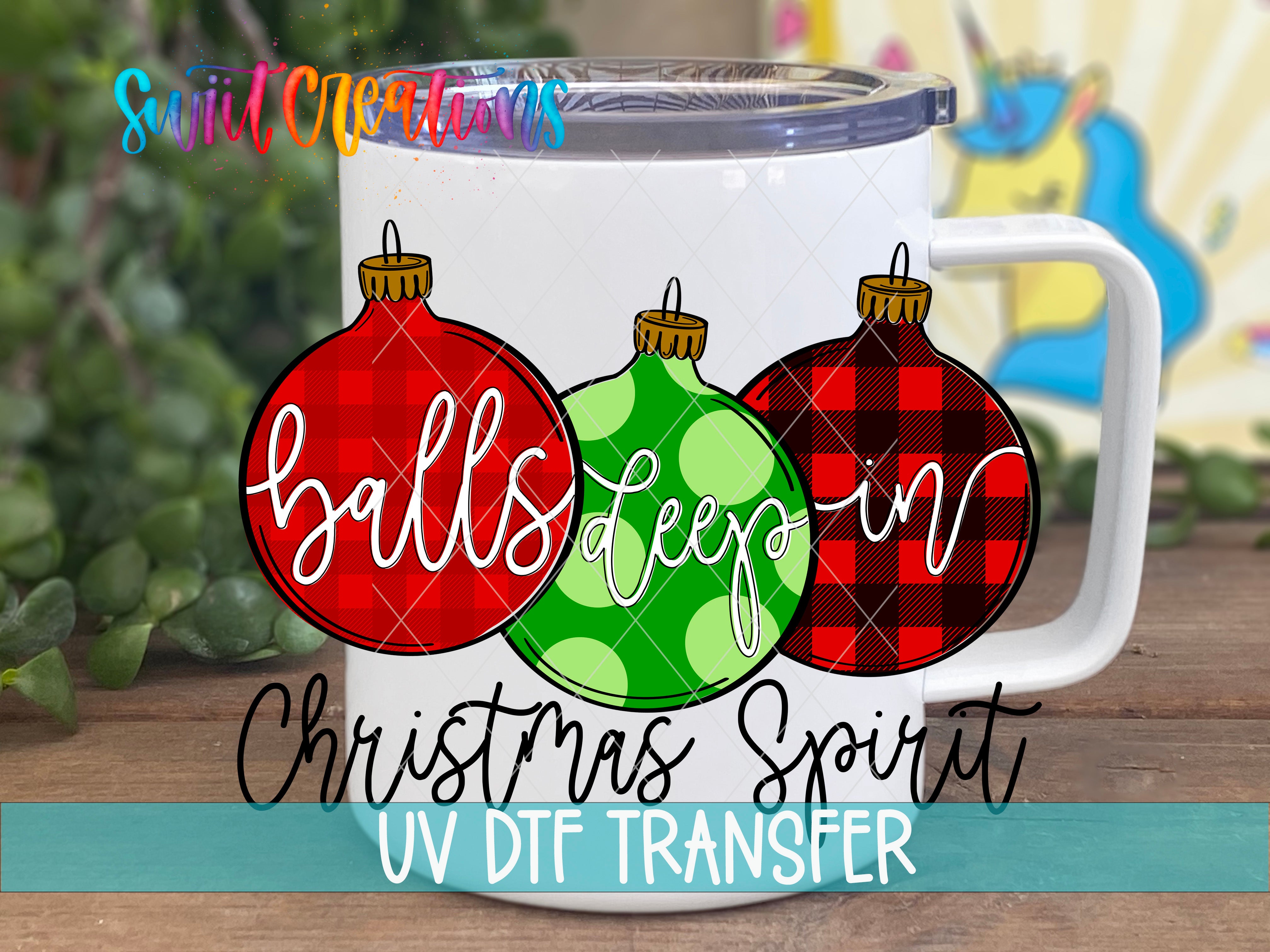 A white mug with a colorful illustration of Christmas ornaments and the text "balls deep" and "Christmas Spirit" printed on it.