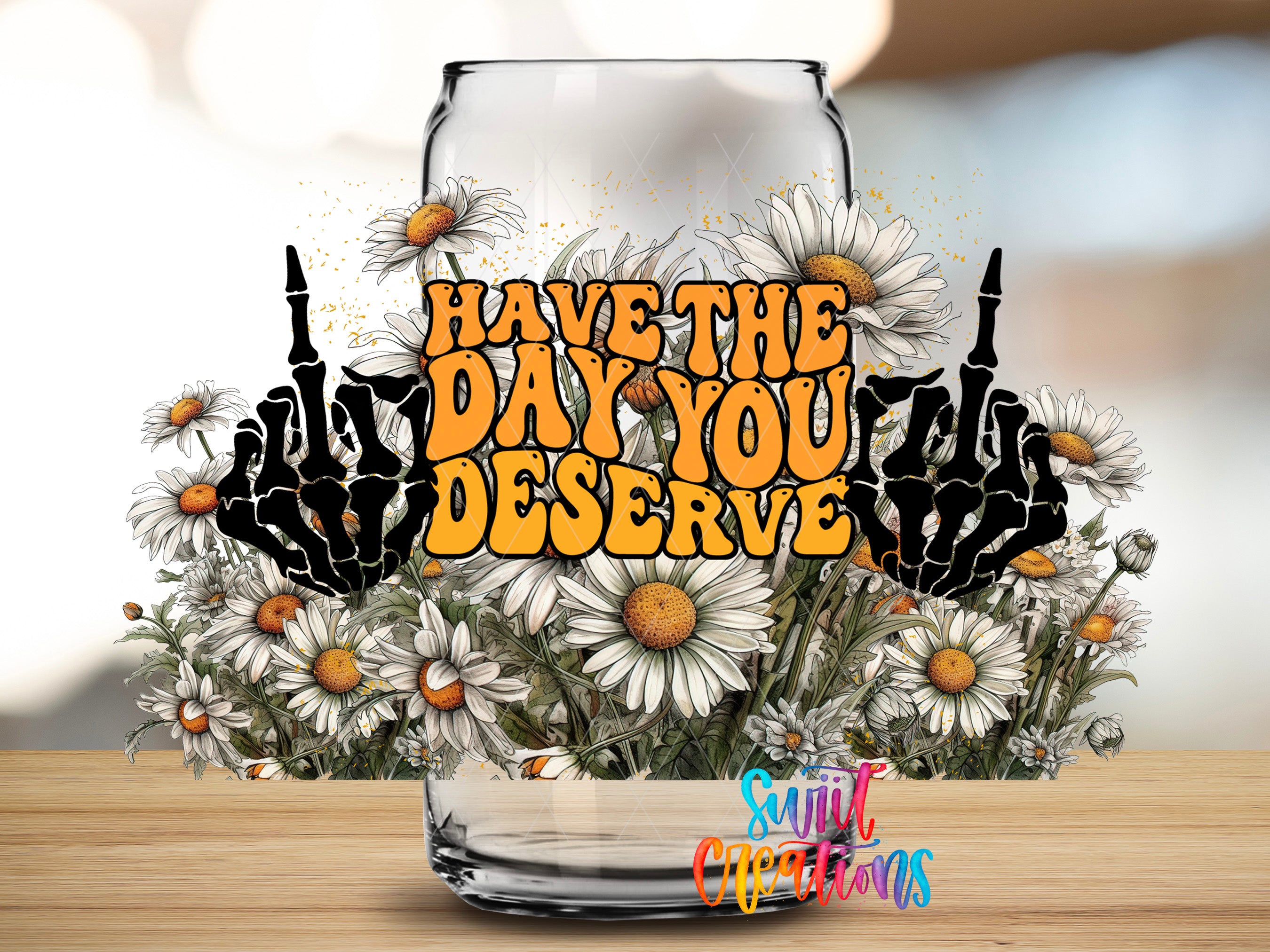 a glass jar filled with white and yellow flowers, with the text "Have the day you deserve" written on it.