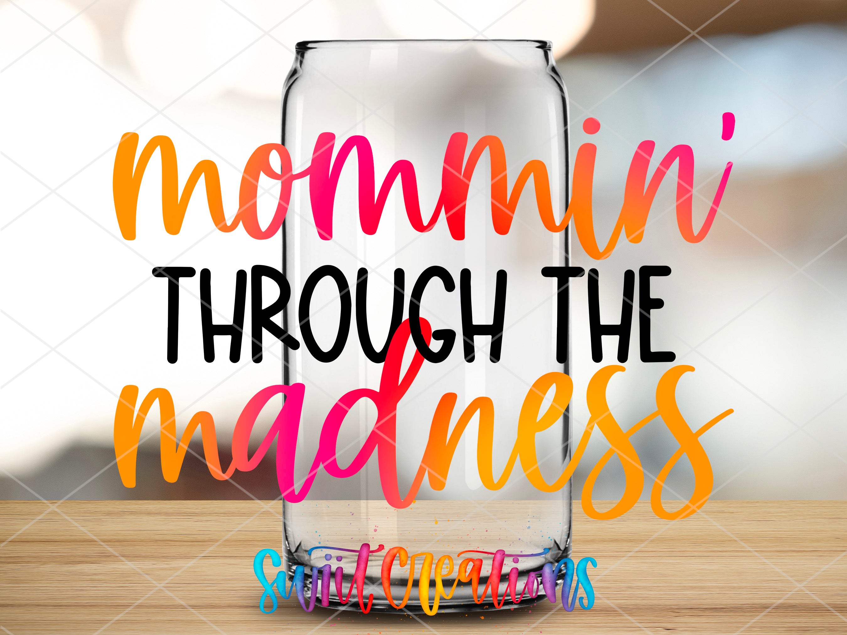 a glass jar with the words, momin'through the madness
