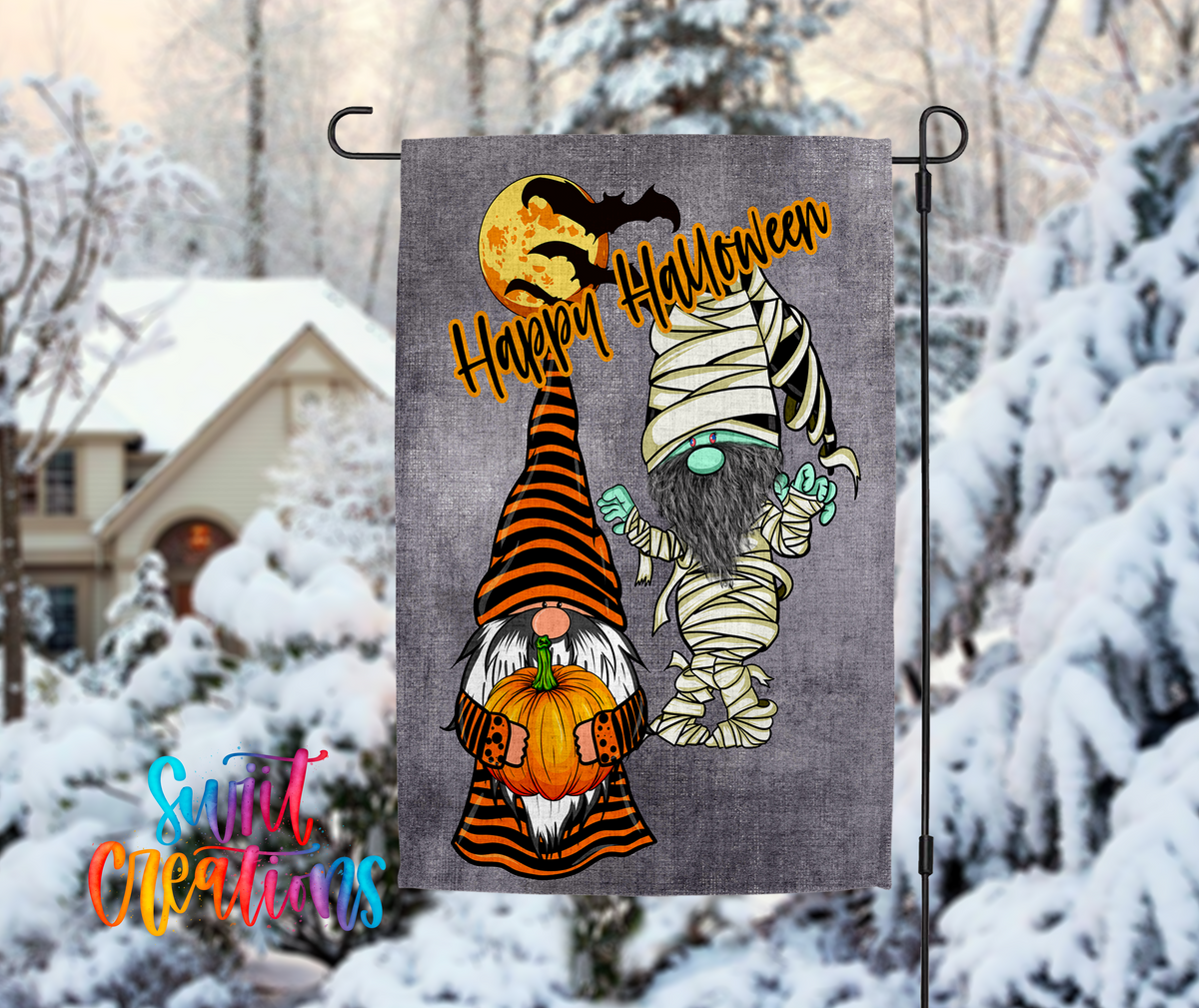 A Halloween-themed garden flag featuring two gnomes dressed in costumes, one as a mummy and the other as a gnome, against a snowy background.