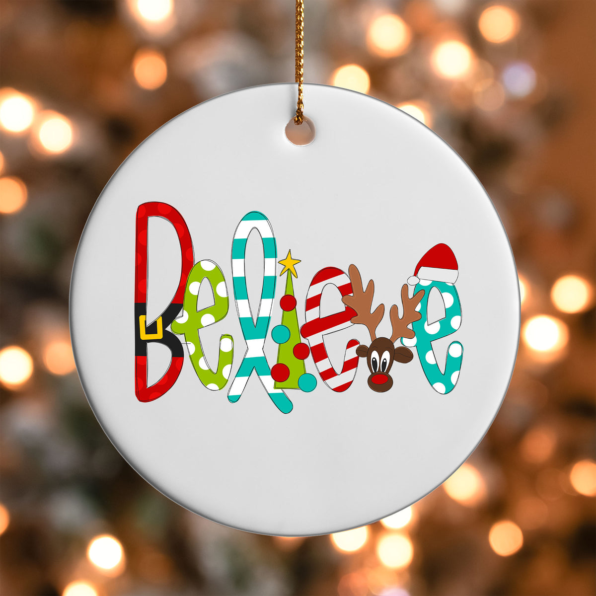 Believe ornament UV DTF transfer on a round white ornament with a bokeh light background