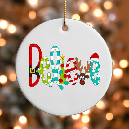 Believe ornament UV DTF transfer on a round white ornament with a bokeh light background
