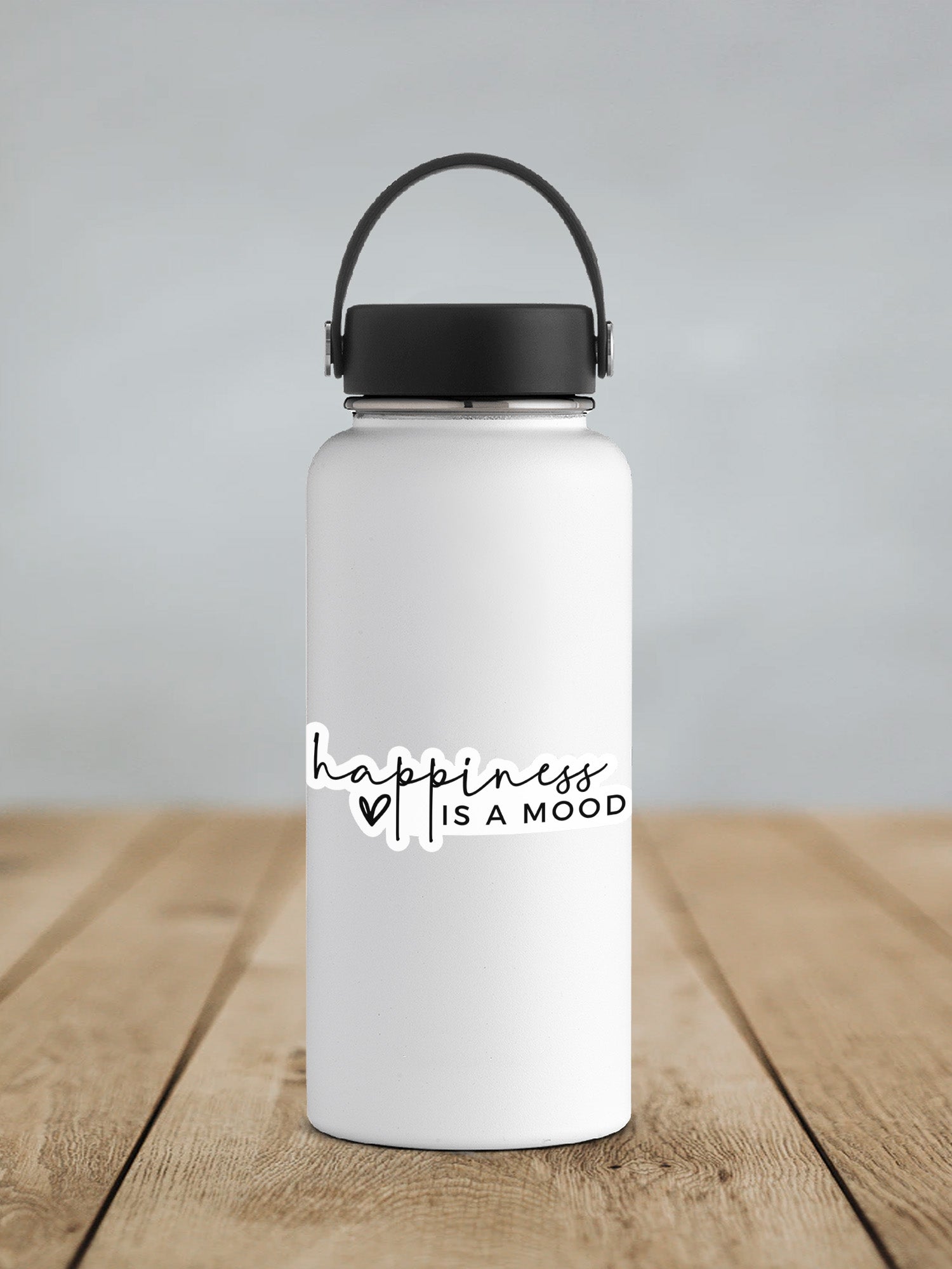 a white water bottle sitting on top of a wooden table
