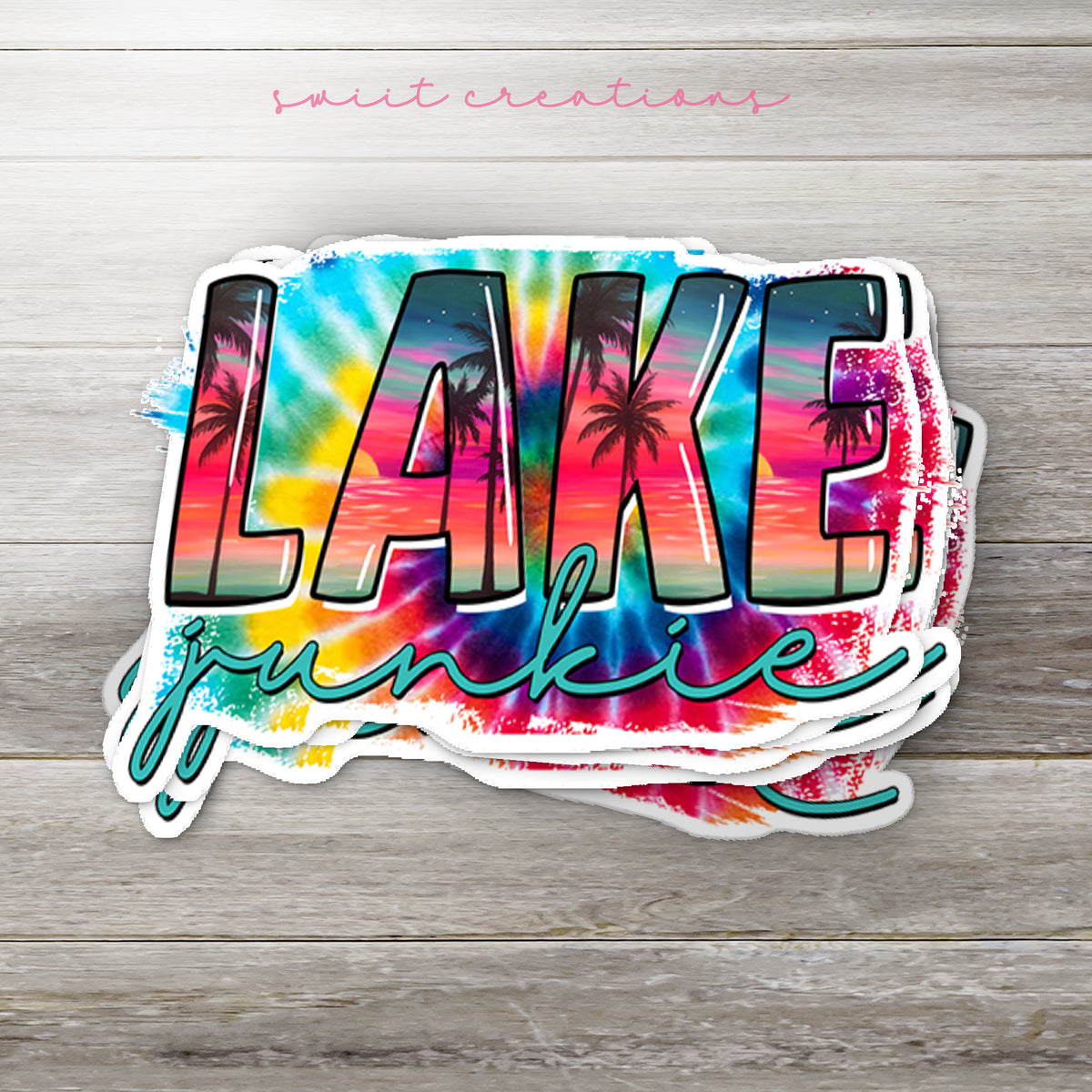 Stack of Lake Junkie glossy stickers on a gray wood table