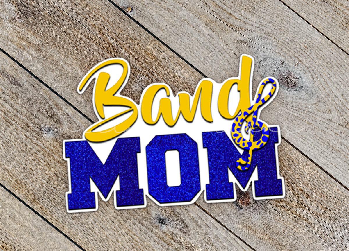 Close-up of the Gold and Blue Band Mom sticker on rustic wood