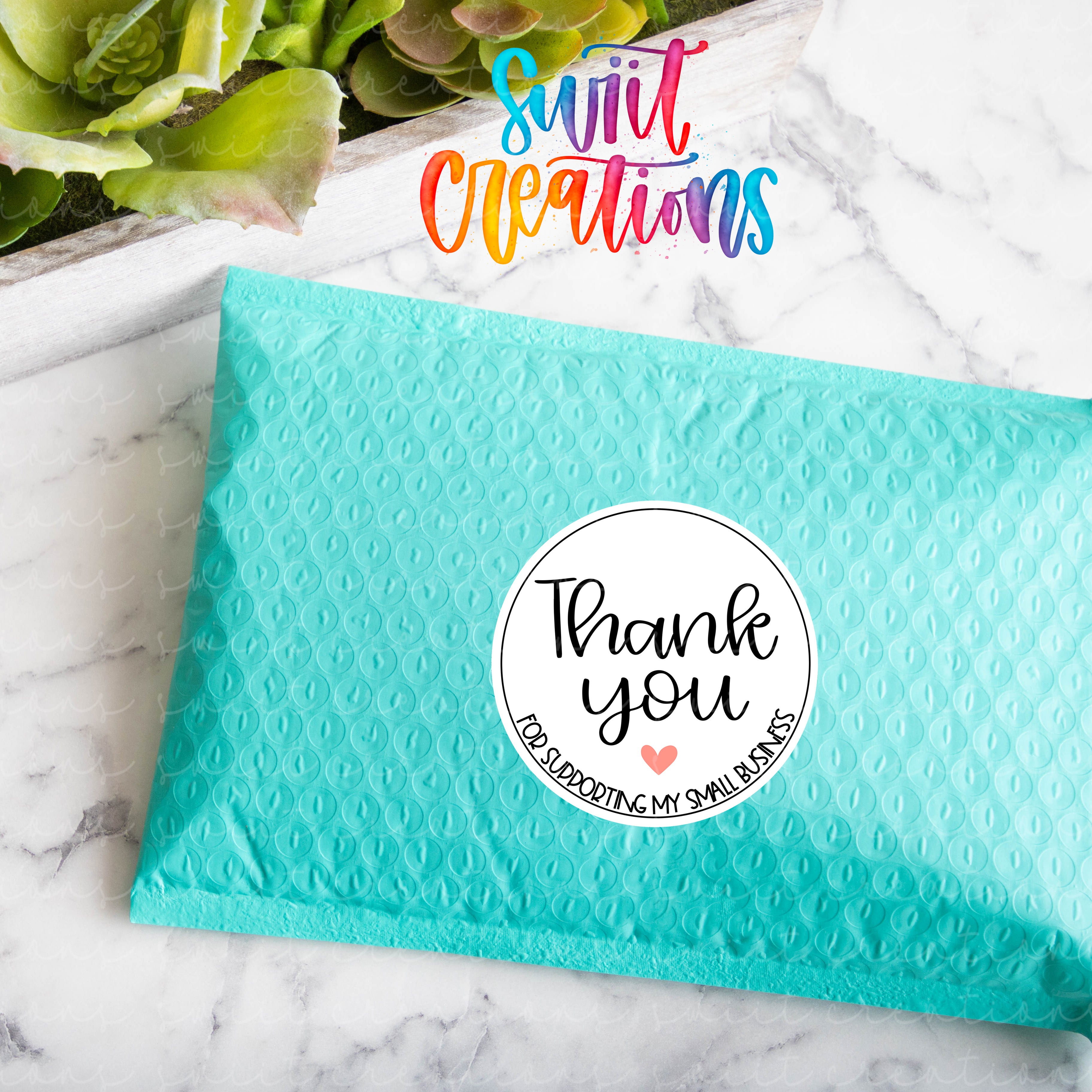 a blue envelope with a thank you sticker on it