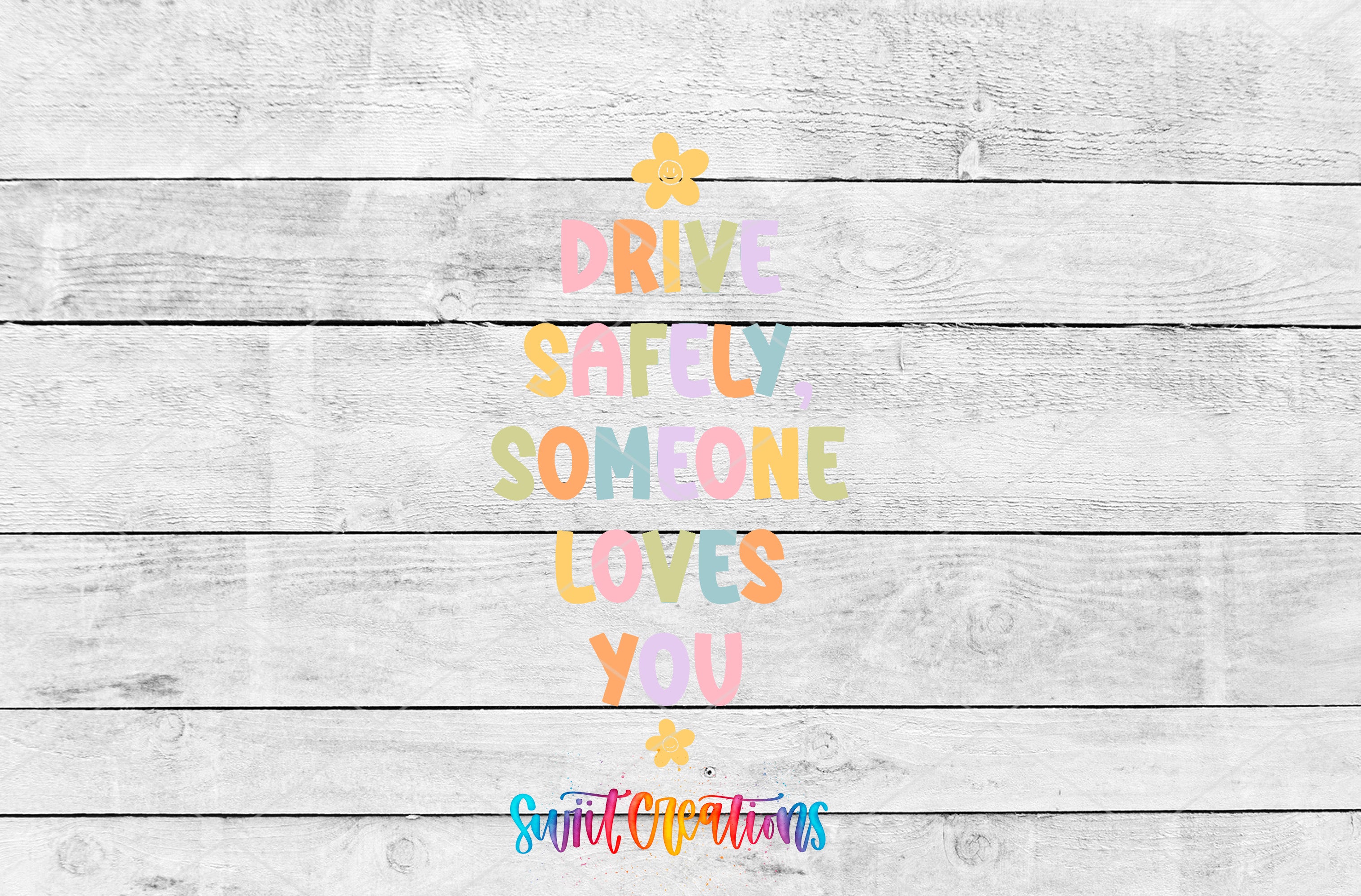 a colorful text message that reads "DRIVE SAFELY SOMEONE LOVES YOU" against a white wooden background.