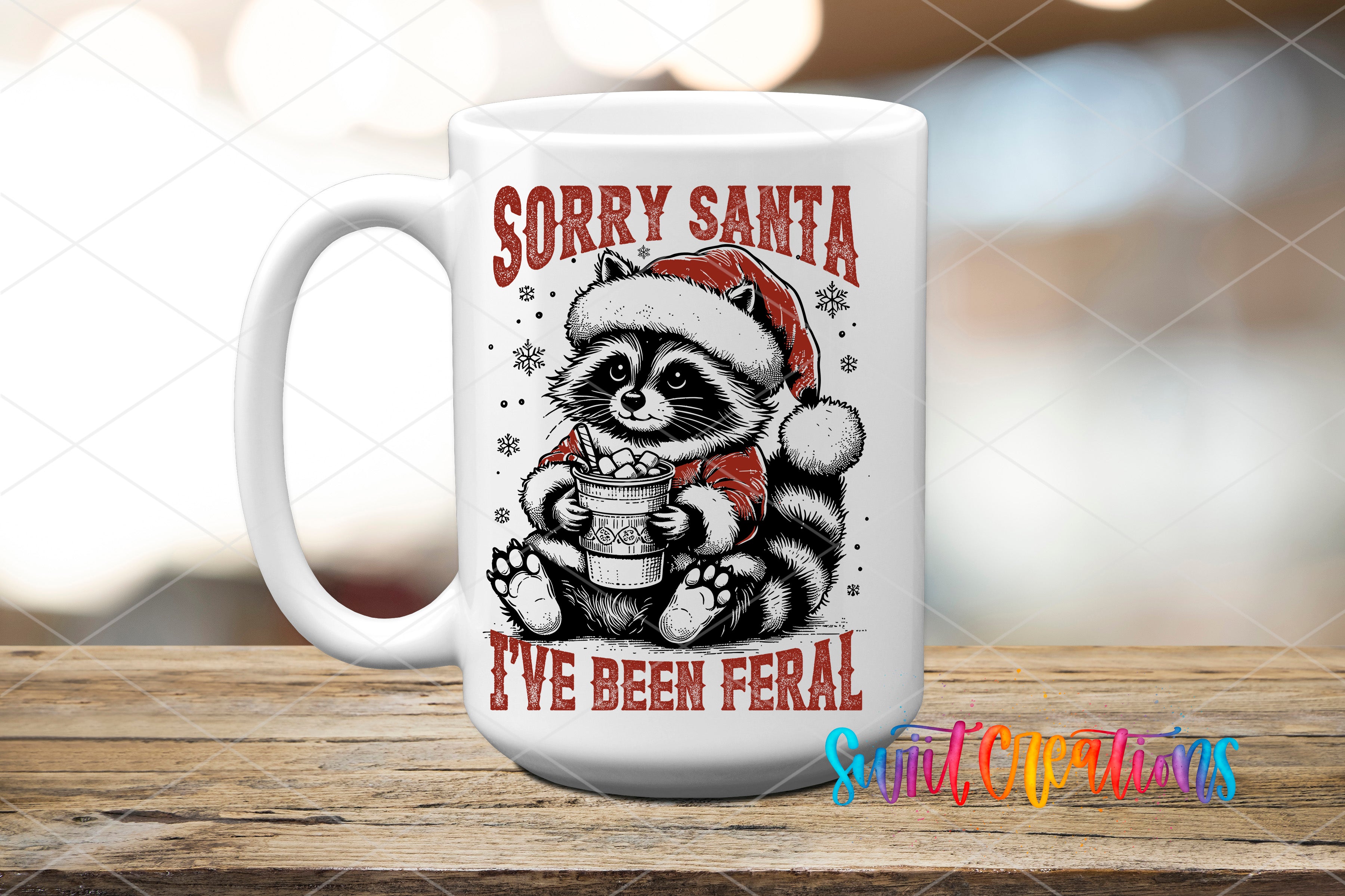 A white ceramic mug with a graphic design featuring a raccoon wearing a Santa hat and holding a bucket of candy, along with the text "Sorry Santa I've been feral" printed on it.