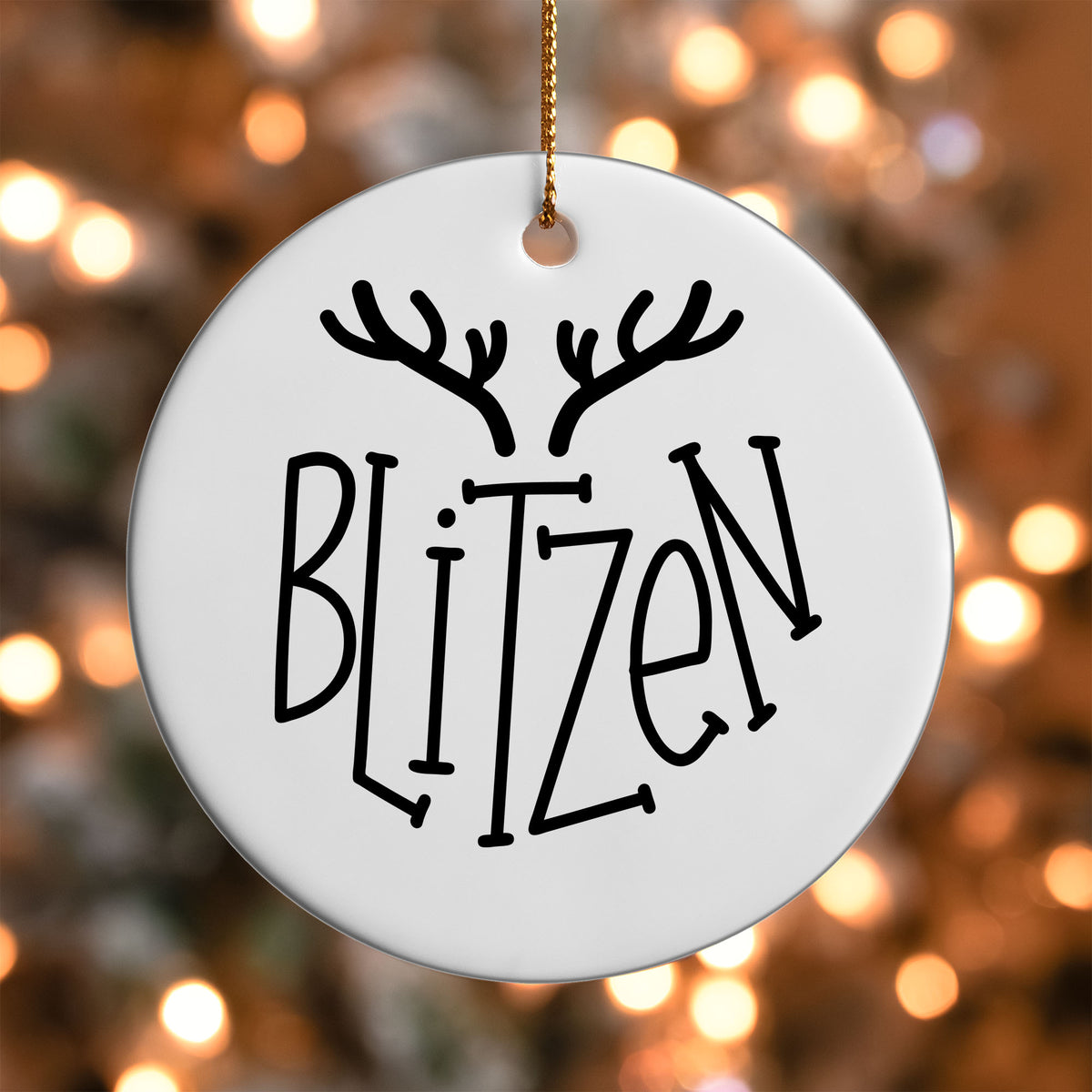 Blitzen Reindeer Name ornament UV DTF transfer on a round white ornament with a bokeh light background