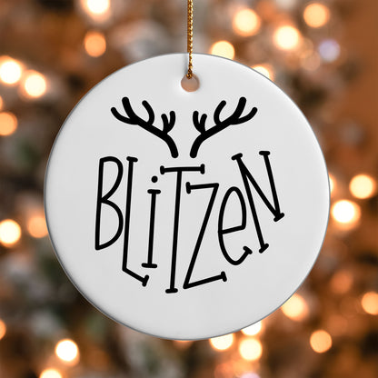 Blitzen Reindeer Name ornament UV DTF transfer on a round white ornament with a bokeh light background