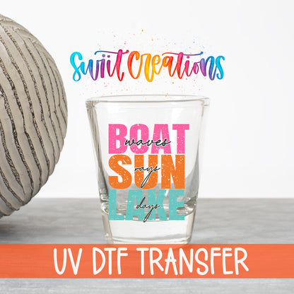 Boat Waves Sun Rays Lake Days UV DTF transfer on a clear shot glass with the Swiit Creations logo and UV DTF Transfer banner