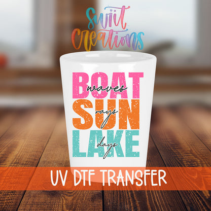 Boat Waves Sun Rays Lake Days shot glass transfer on a white shot glass on a wooden table