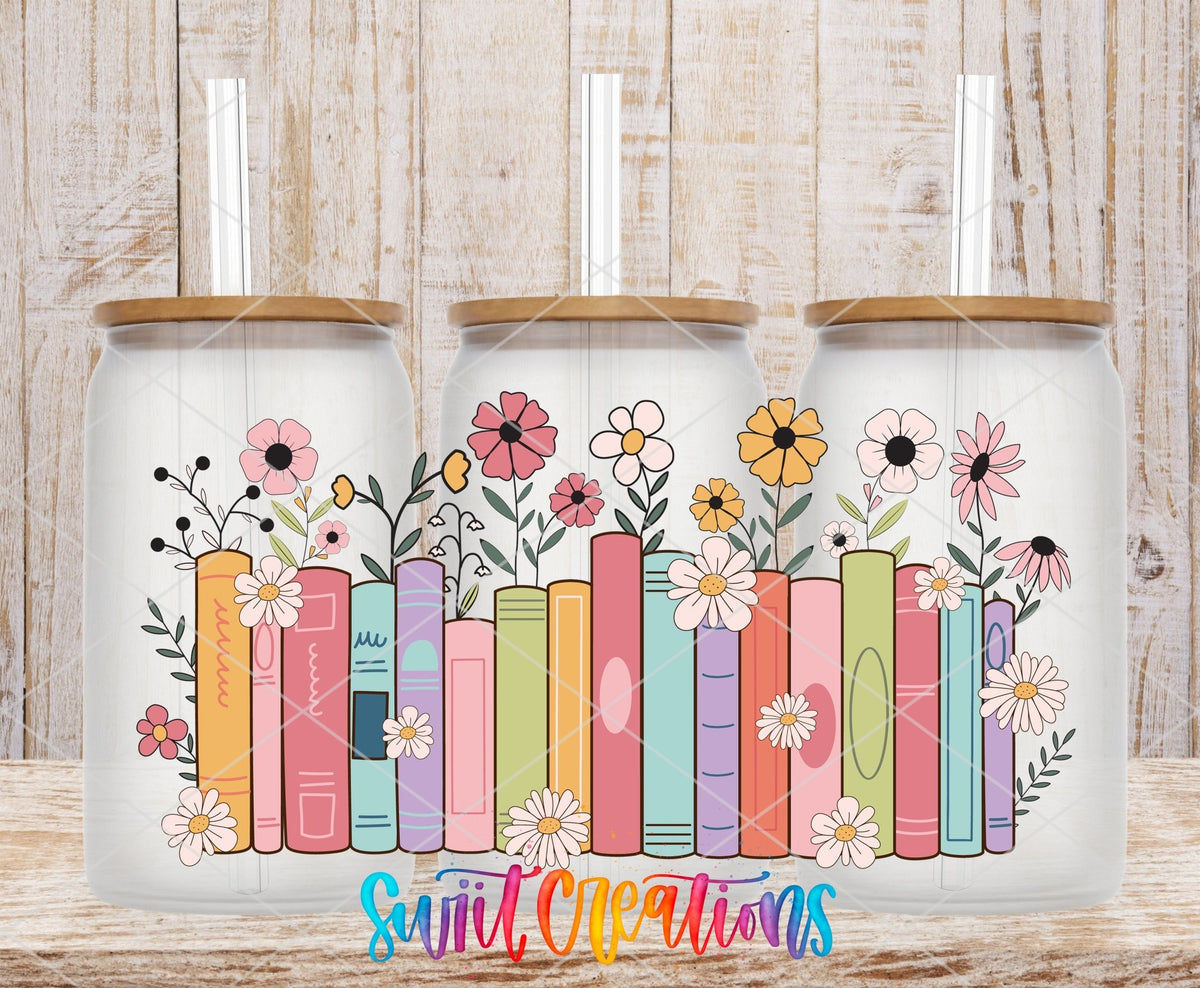 Books and Flowers UV DTF wrap on three clear glass cans with bamboo lids