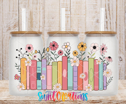 Books and Flowers UV DTF wrap on three clear glass cans with bamboo lids