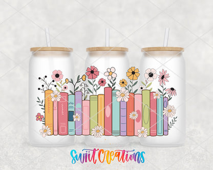 Books and Flowers UV DTF wrap on three frosted glass cans