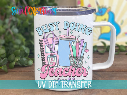Busy Doing Teacher Stuff UV DTF transfer on a white stainless steel mug with a lid
