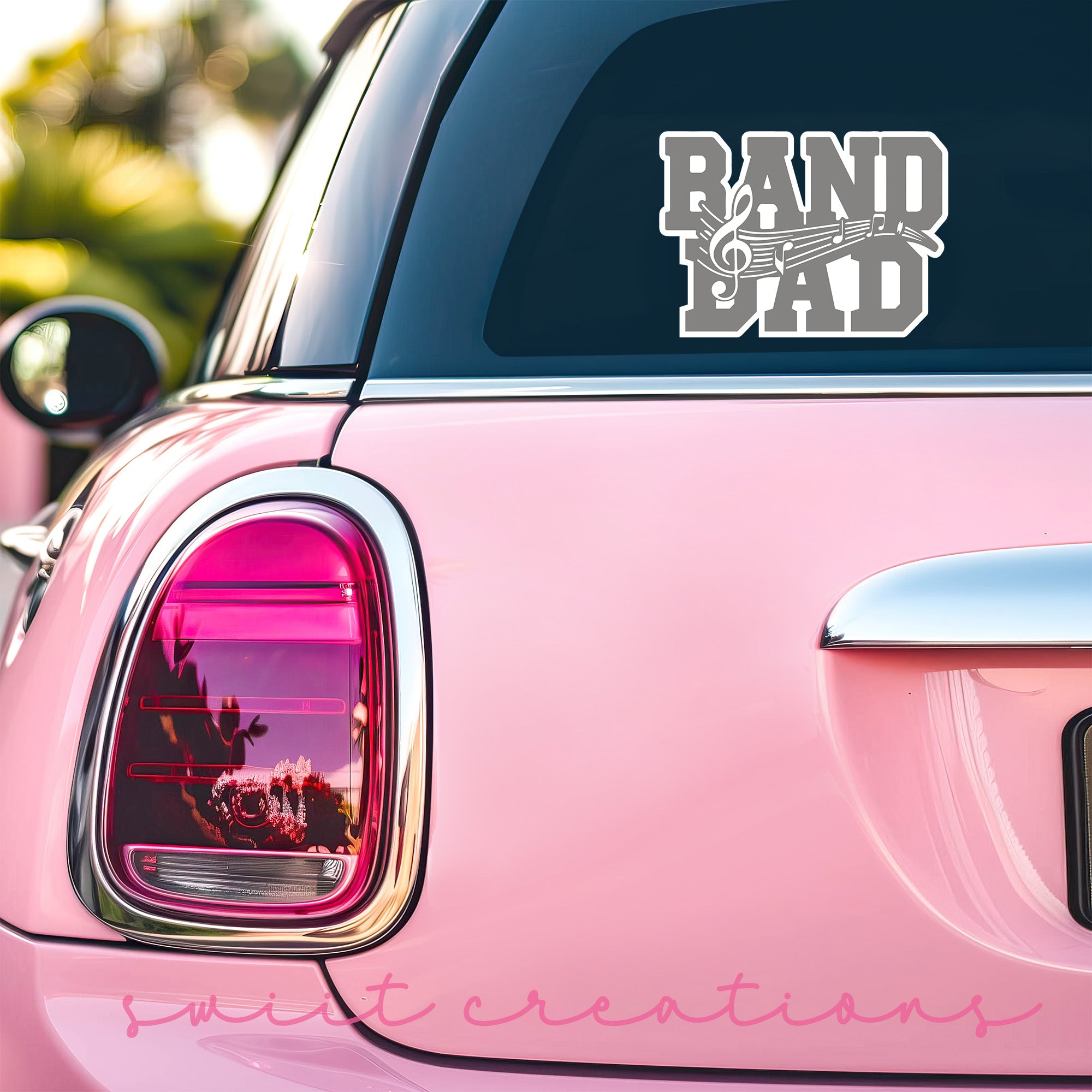 a pink car that has a sticker on it