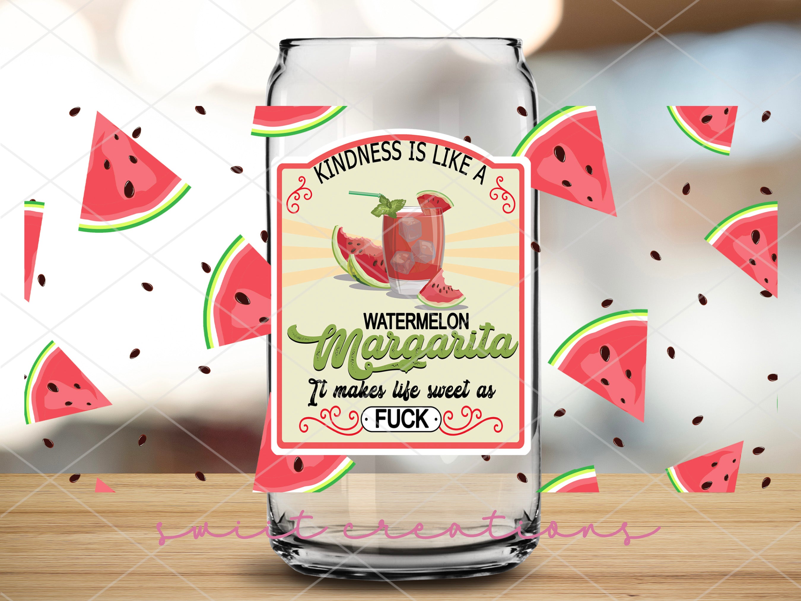 a bottle of watermelon margarita on a wooden table