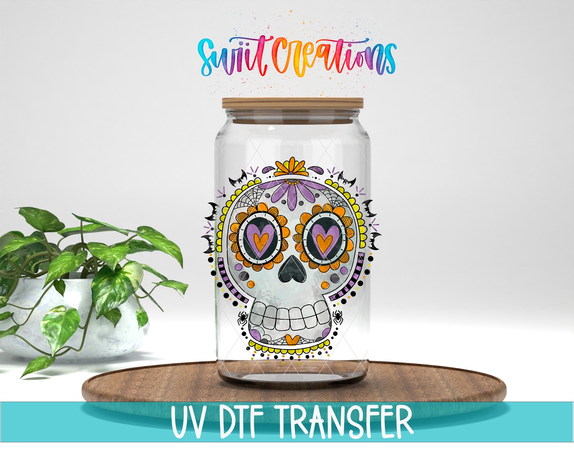 A glass jar with a colorful, skull-like design on it, placed on a wooden surface. There is a potted plant to the left of the jar, and the text "Swift Creations" is written above the jar.