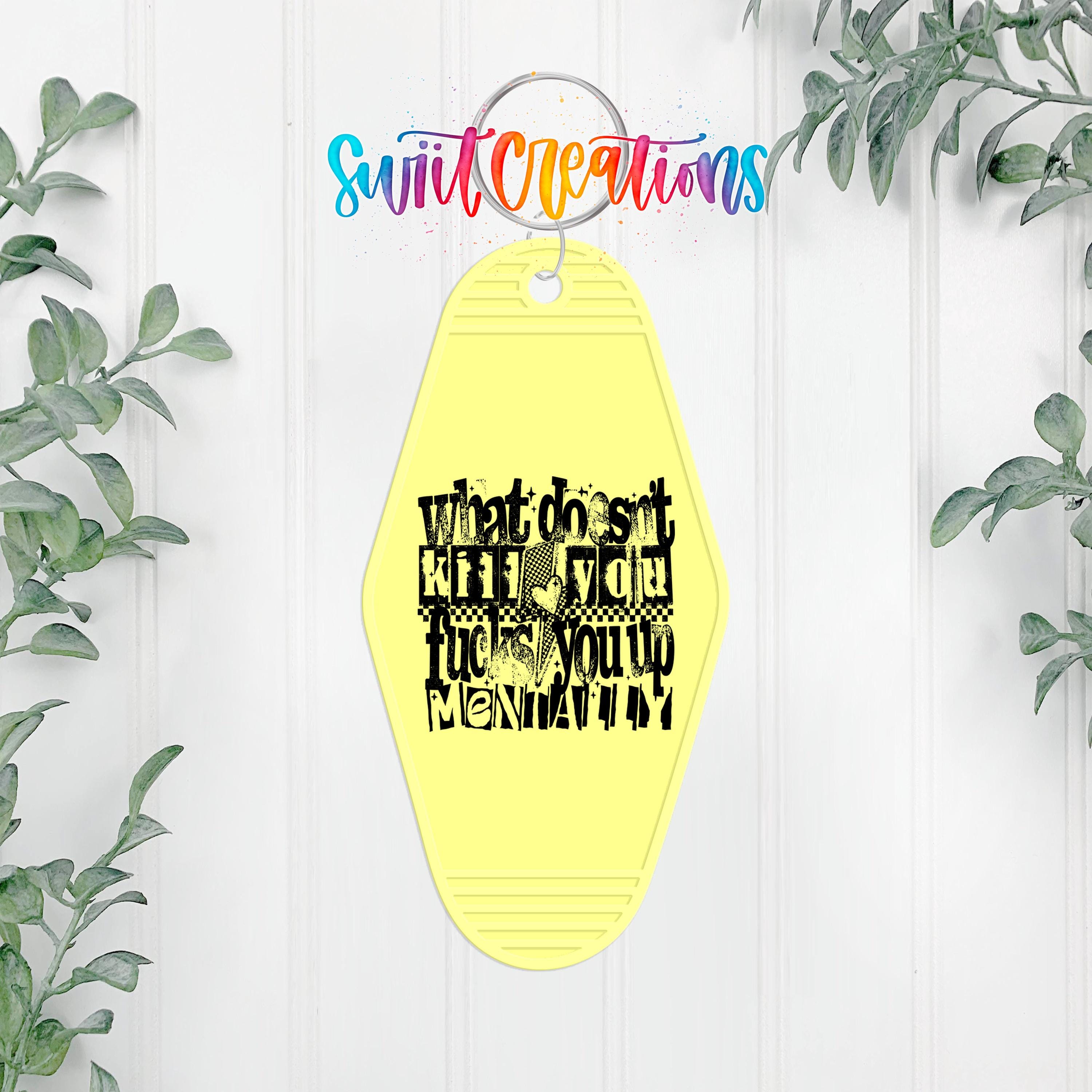 A yellow keychain with a black text design that reads "What do you think KICK F*CK MONITOR?"