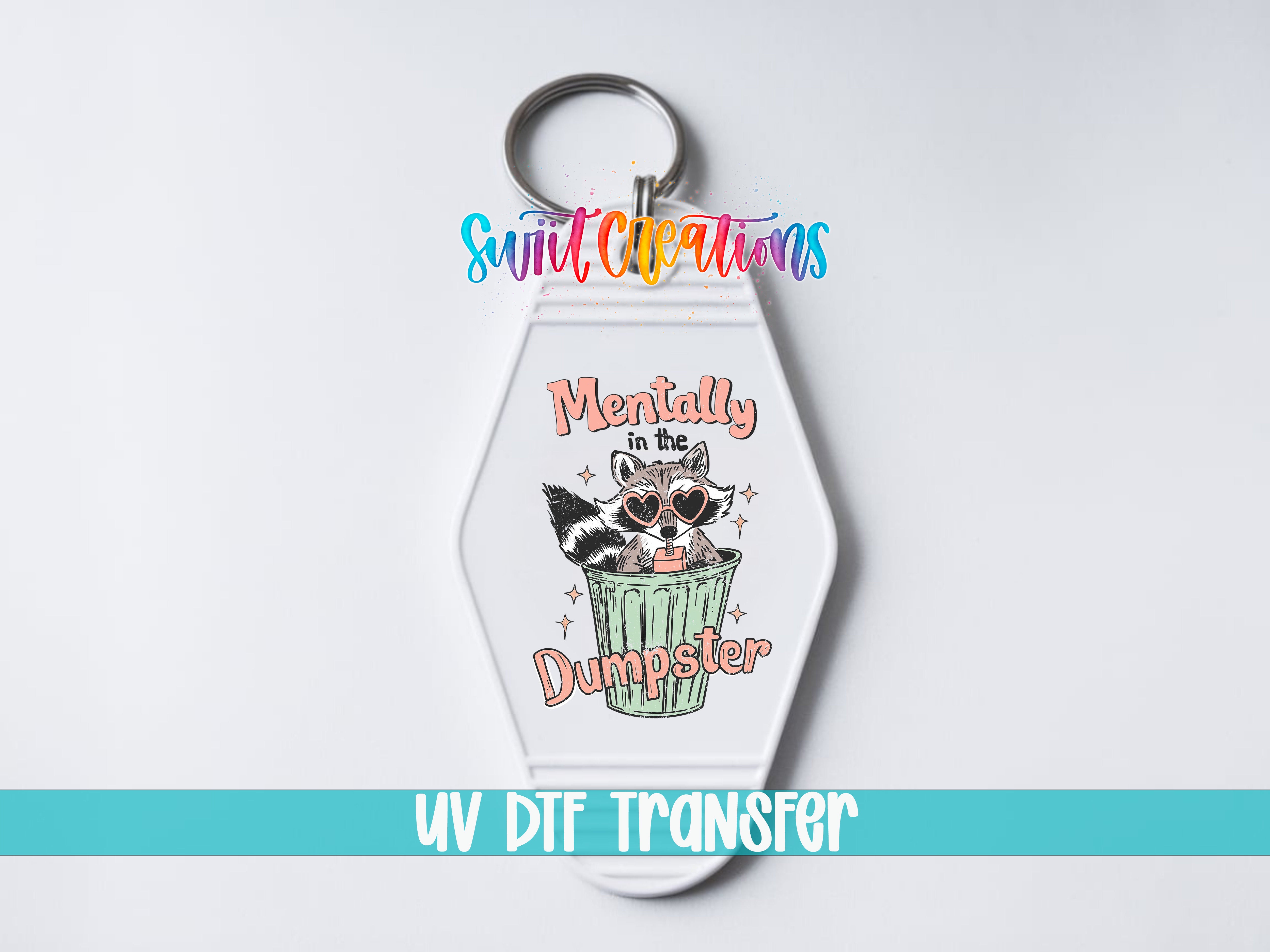 A keychain with a raccoon wearing sunglasses and the text "Mentally in the Dumpster" printed on it.