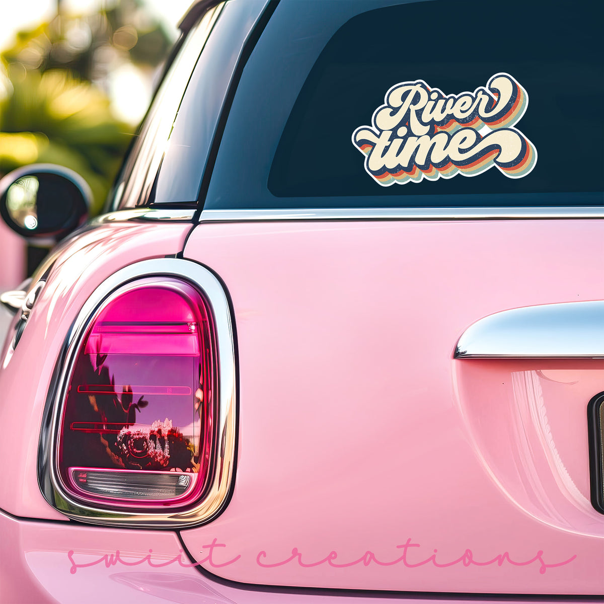 a pink car with a sticker that says river time