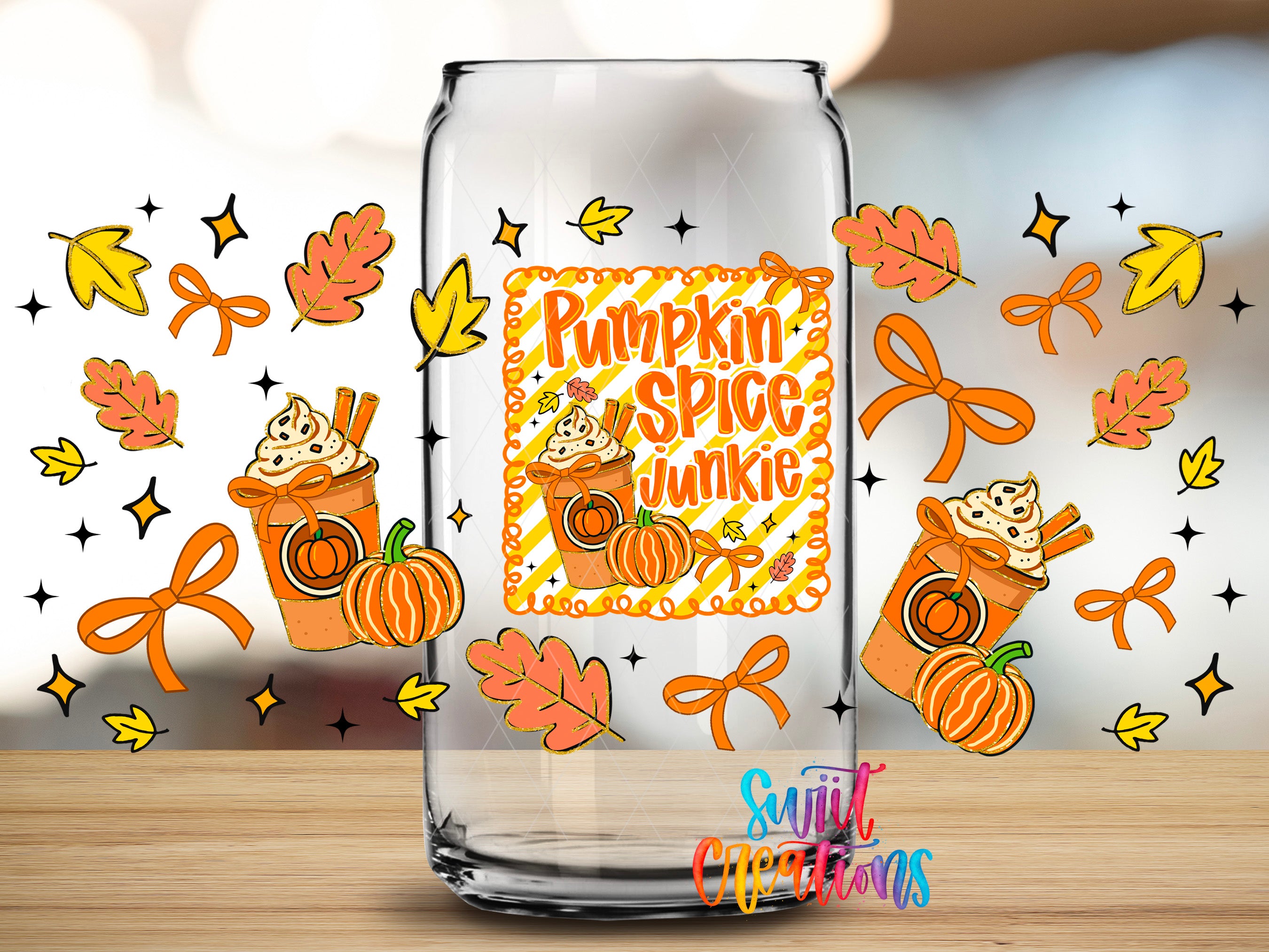A glass can with a pumpkin spice junkie design, surrounded by autumn leaves, pumpkins, and other fall-themed elements.