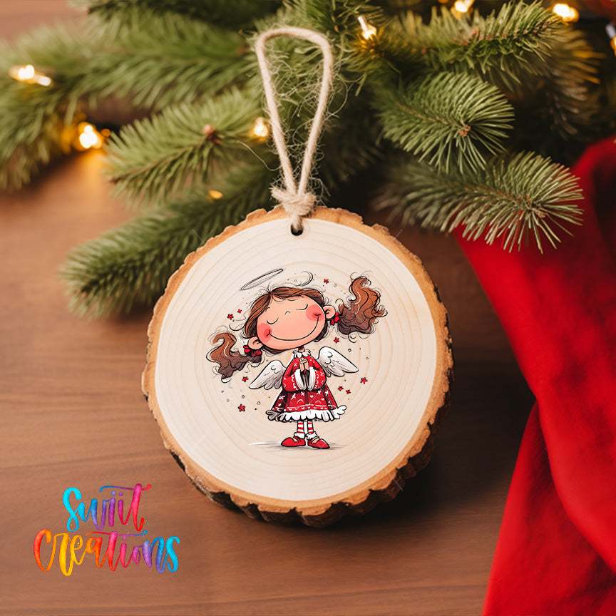 A wooden ornament featuring a smiling girl with wings, hanging on a Christmas tree.