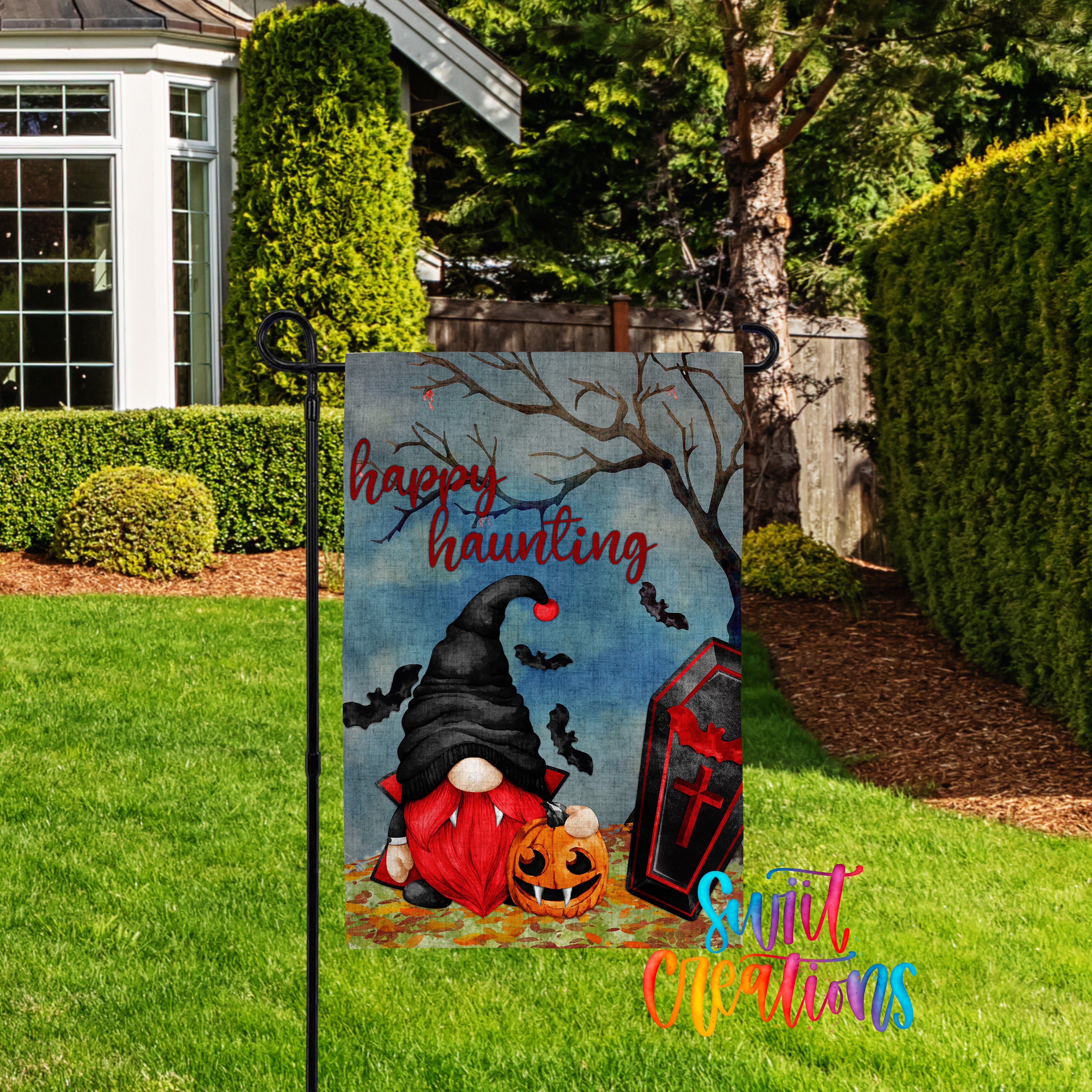 A Halloween-themed garden sign featuring a gnome, a jack-o-lantern, and bats against a spooky background.
