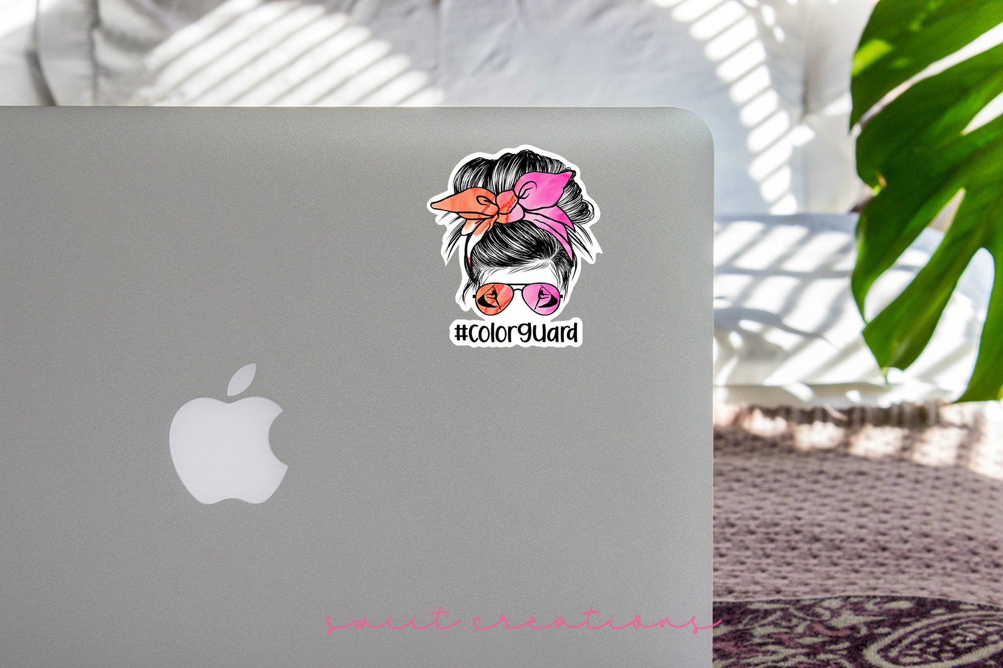 a laptop with a sticker of a woman's head