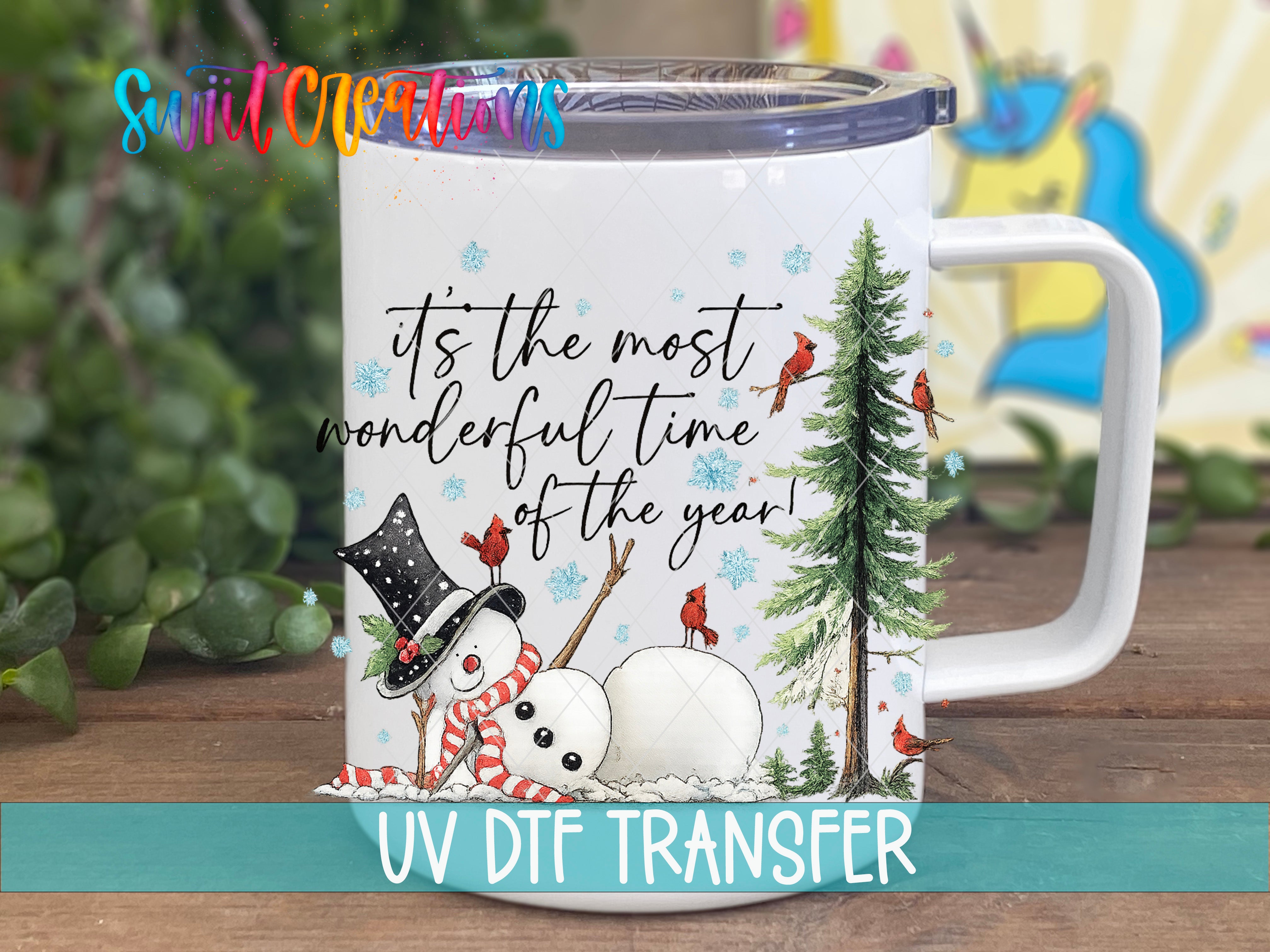 A white mug with a snowman and birds on it, along with a quote about the most wonderful time of the year.