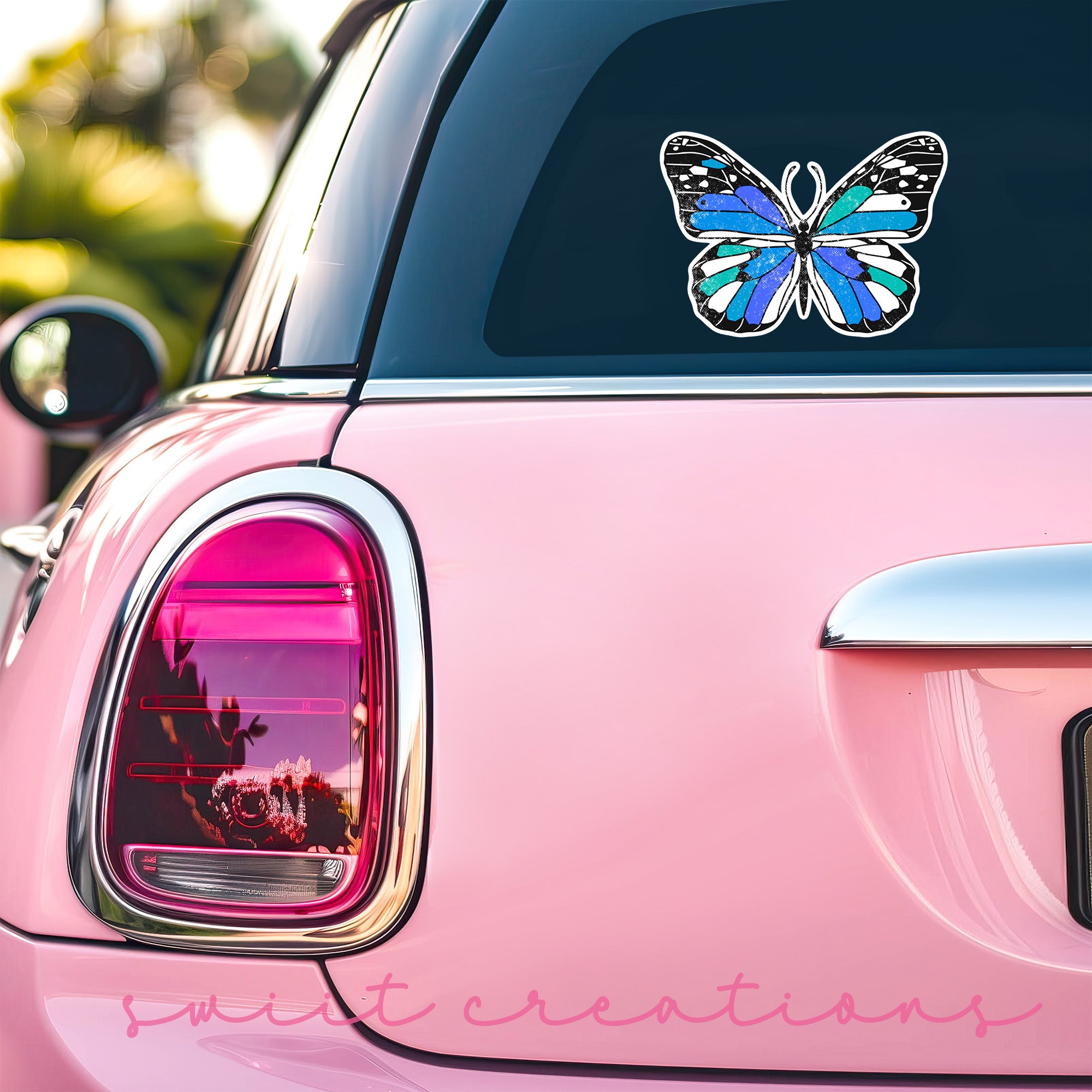a pink car with a butterfly decal on it