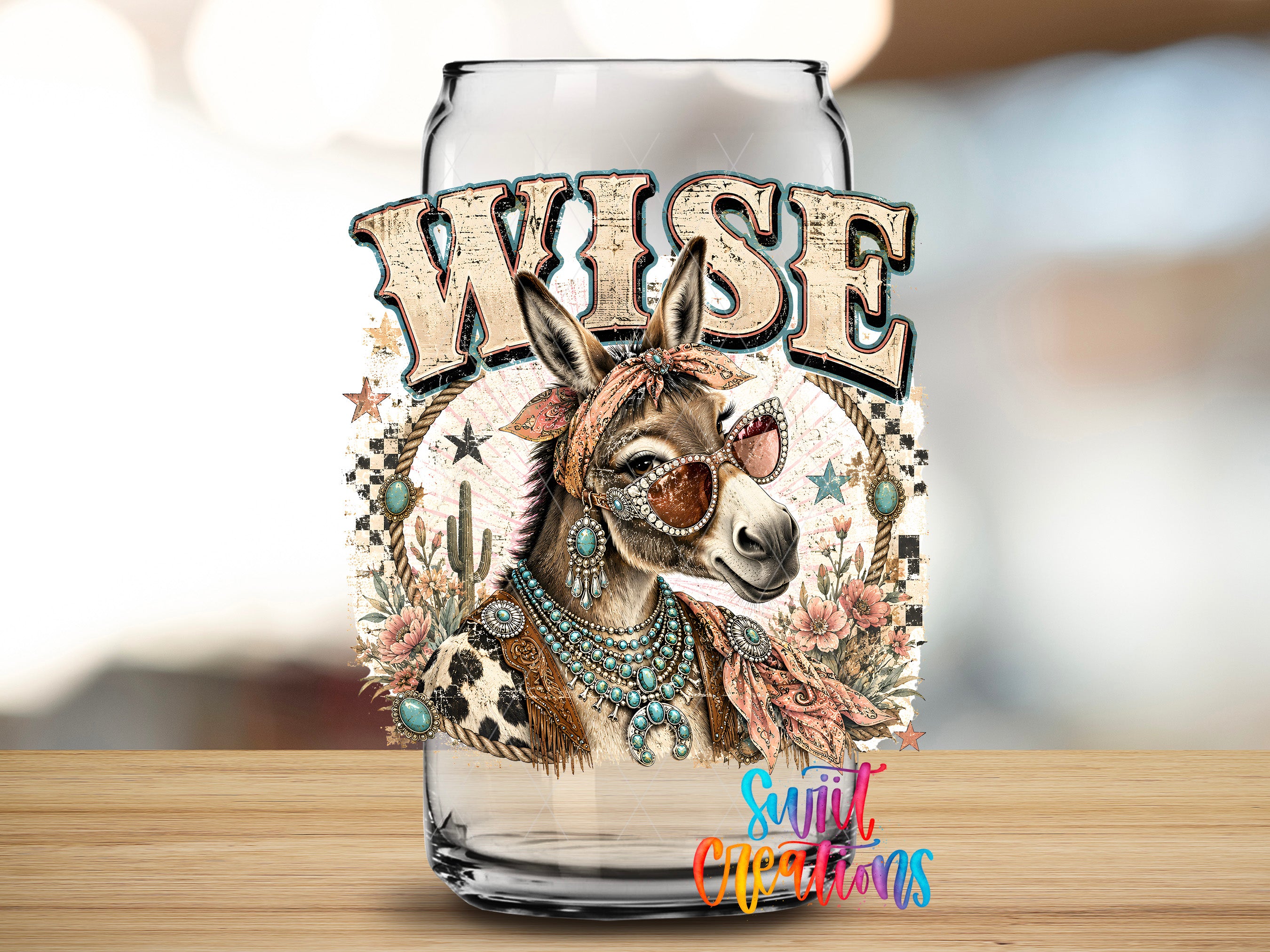 A glass can with a decorative design featuring a donkey wearing sunglasses and jewelry, surrounded by various floral and star motifs.